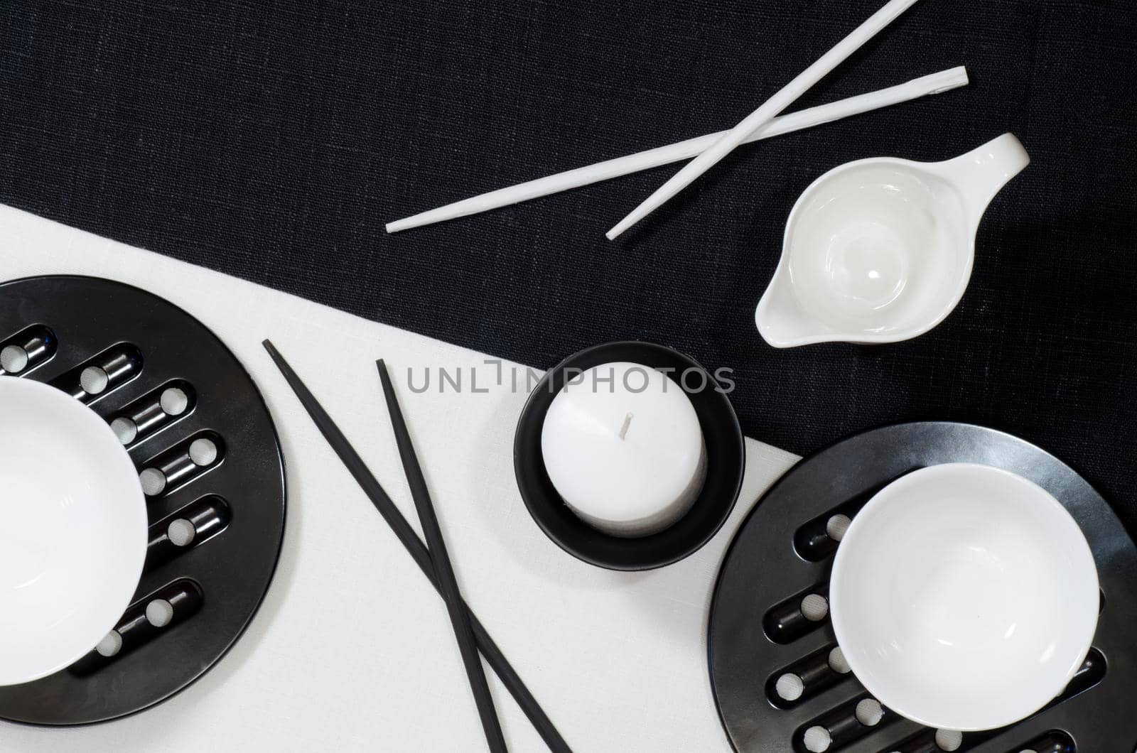 White porcelain on black and white linen tablecloths. White porcelain on black and white linen tablecloths. Abstract still life. From series "Playing with Color"