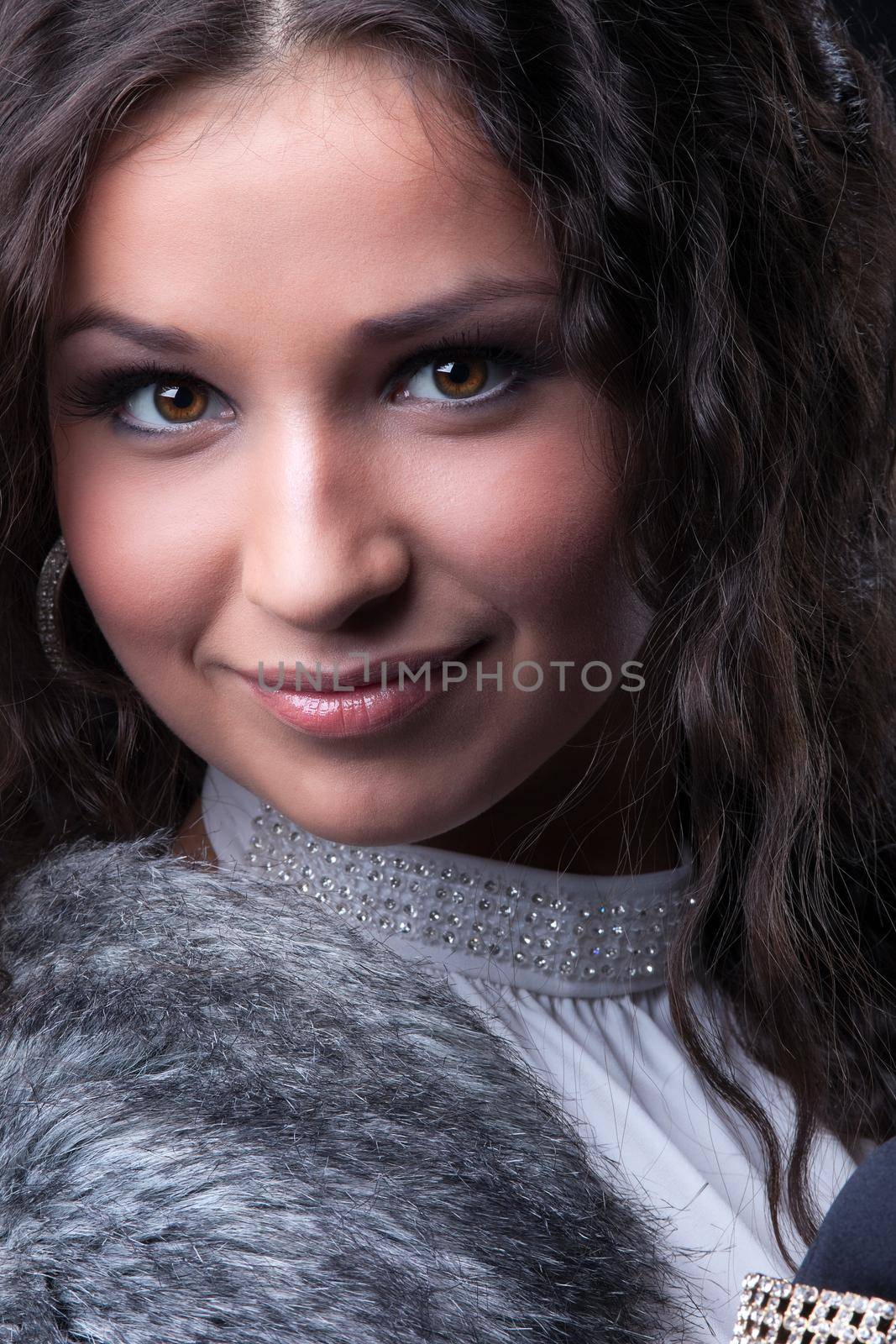 Pretty girl close-up portrait in fur coat