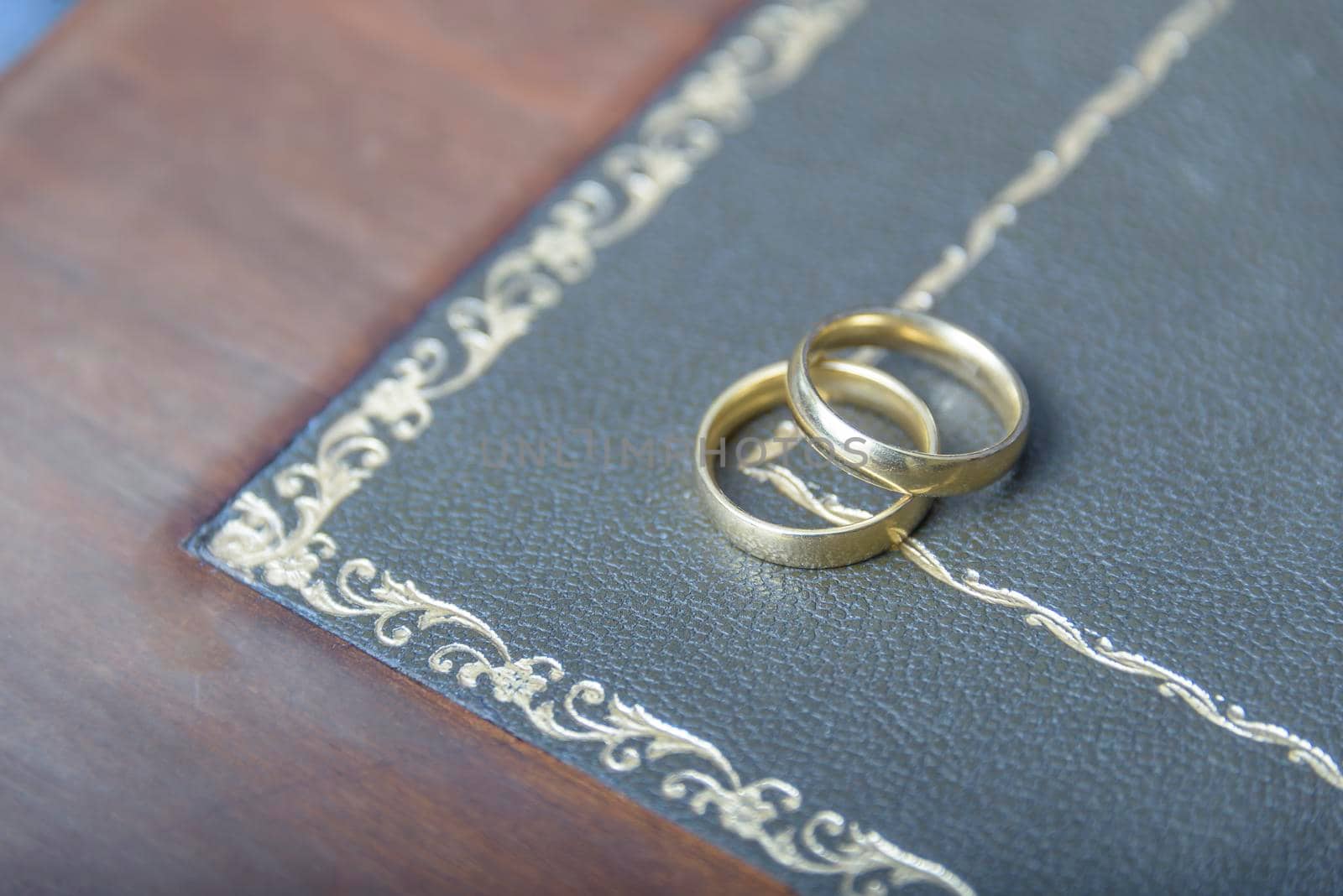 Golden wedding rings with judge gavel, closeup. by jbruiz78