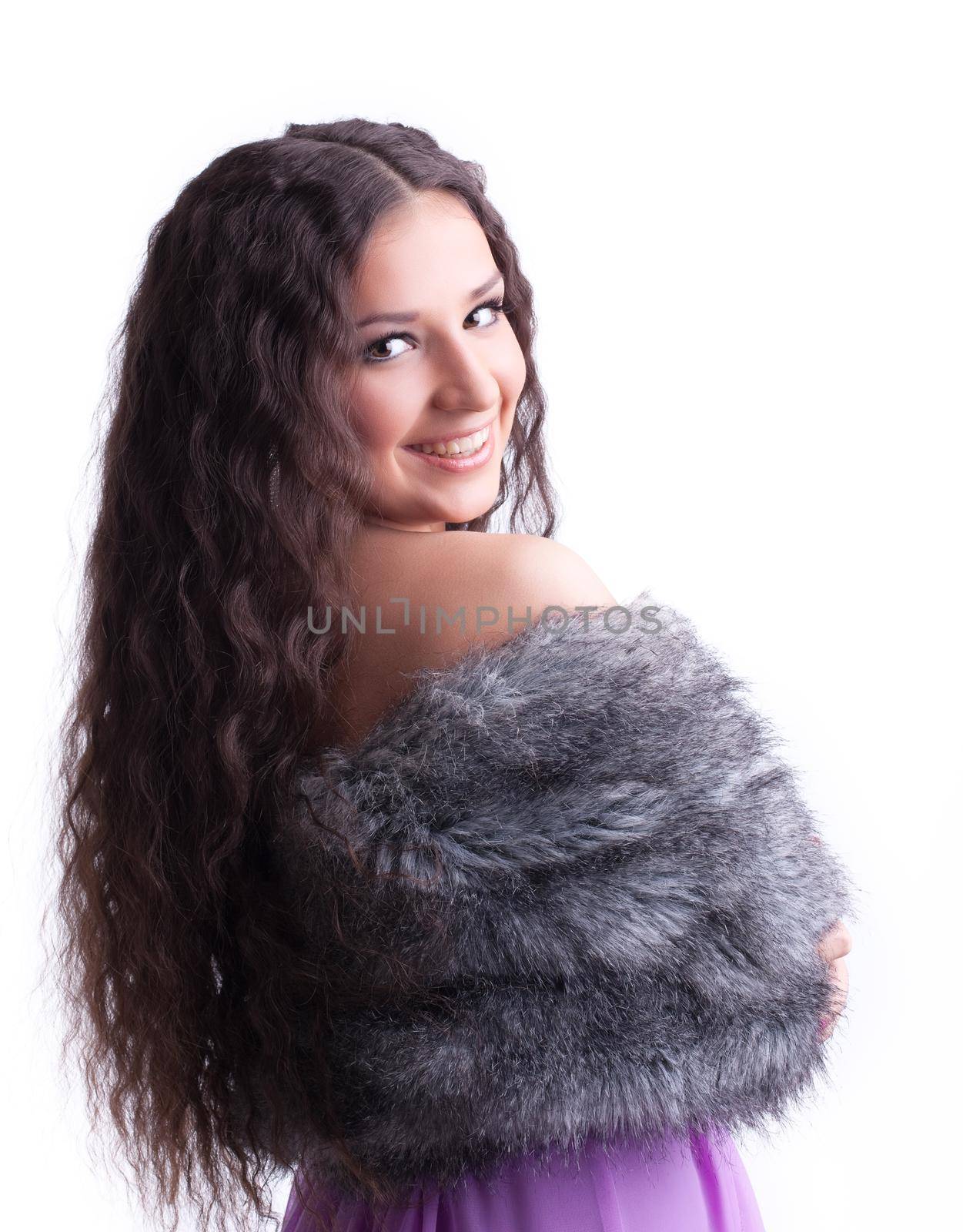 young girl with long hair in fur coat look at you
