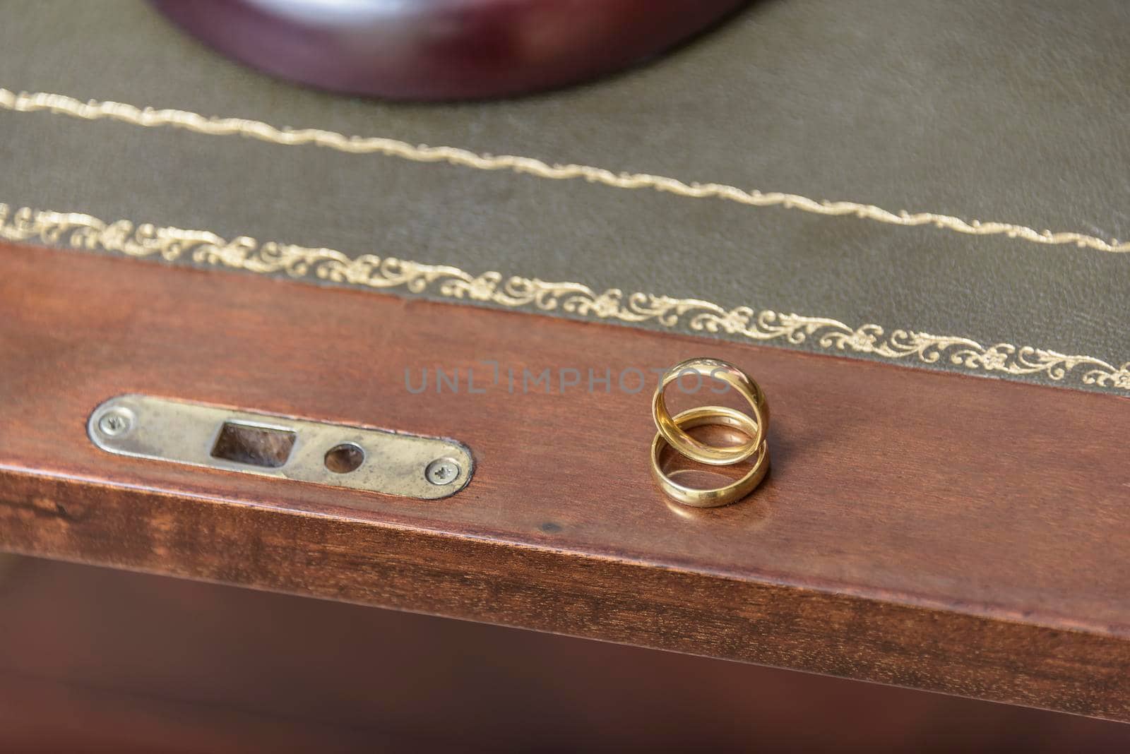 Golden wedding rings with judge gavel, closeup. by jbruiz78