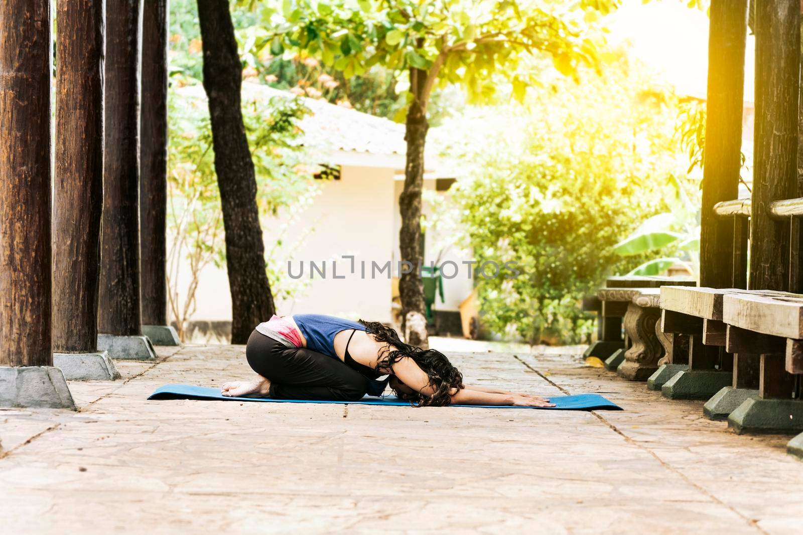 Woman doing yoga child's pose, girl doing yoga child's pose