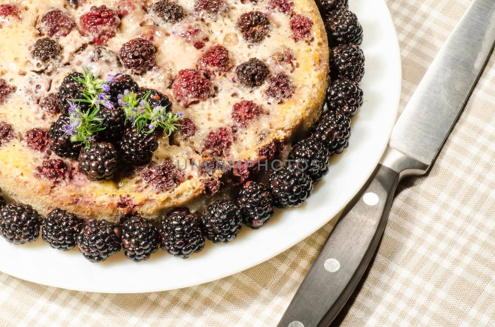 Blackberry Clafoutis on plate with fresh berries. From series "Summer desserts"
