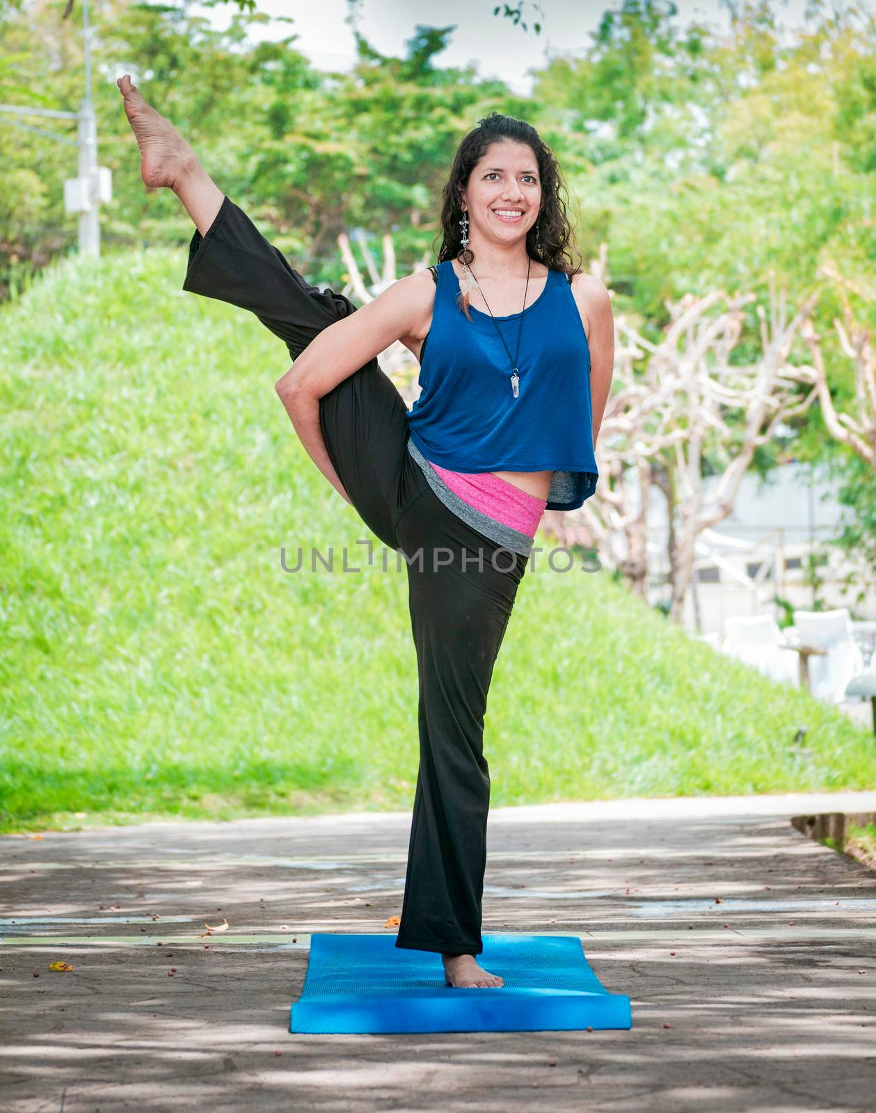 Girl doing yoga bird of paradise, a girl doing yoga outdoors, A woman doing balance yoga, person doing yoga Svarga Dvijasana