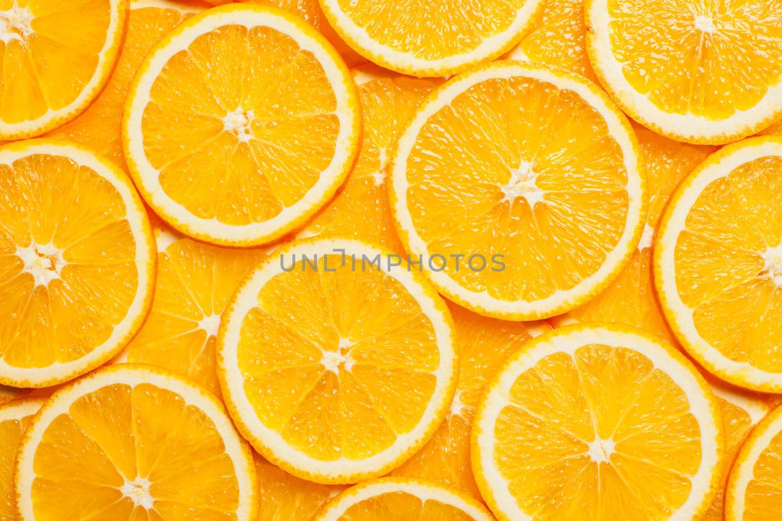 Colorful orange citrus fruit slices background top view