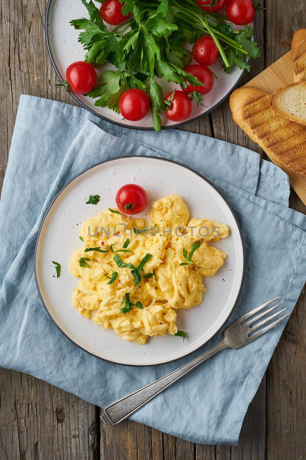 Scrambled eggs, omelette, top view, vertical. Breakfast with pan-fried eggs by NataBene