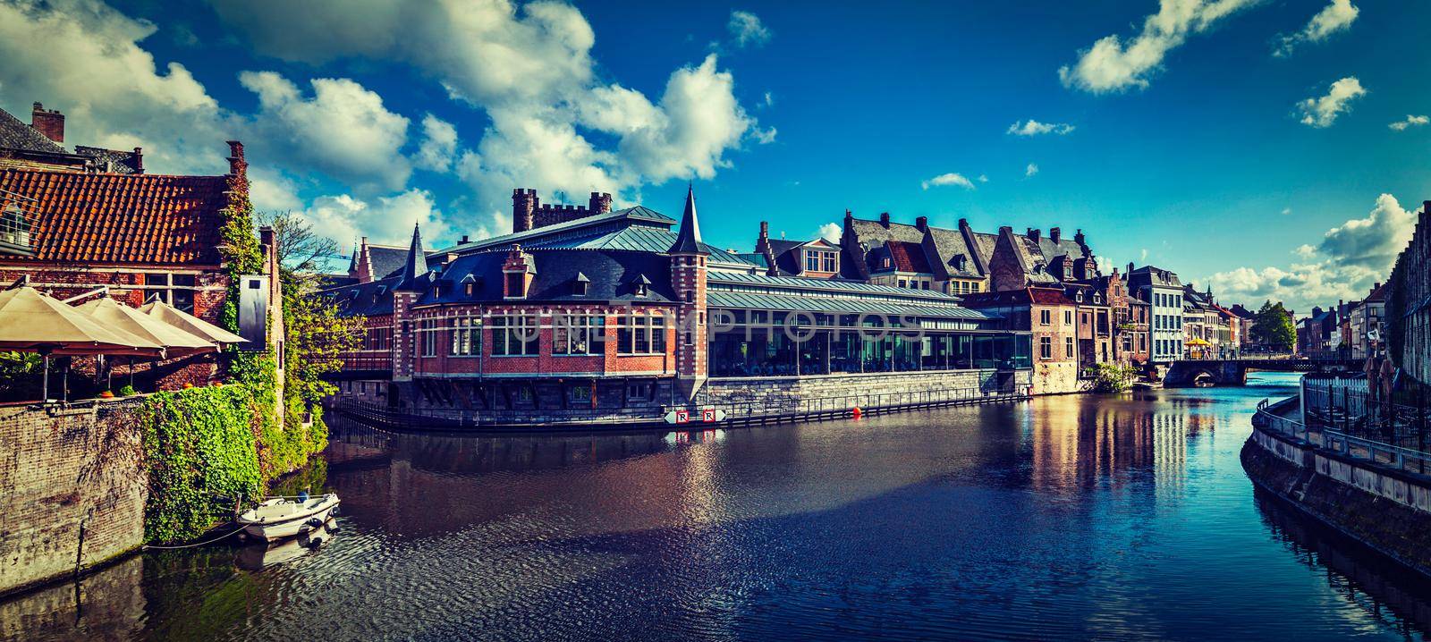 Vintage retro hipster style travel image of Ghent canal and medieval building panorama. Ghent, Belgium