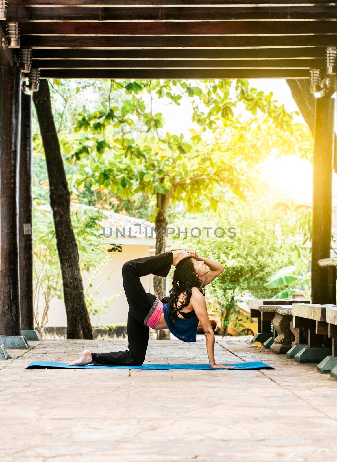 Girl doing yoga and quadricep stretching fitness, Woman doing quadriceps yoga outdoors, Stretching Yoga Concept