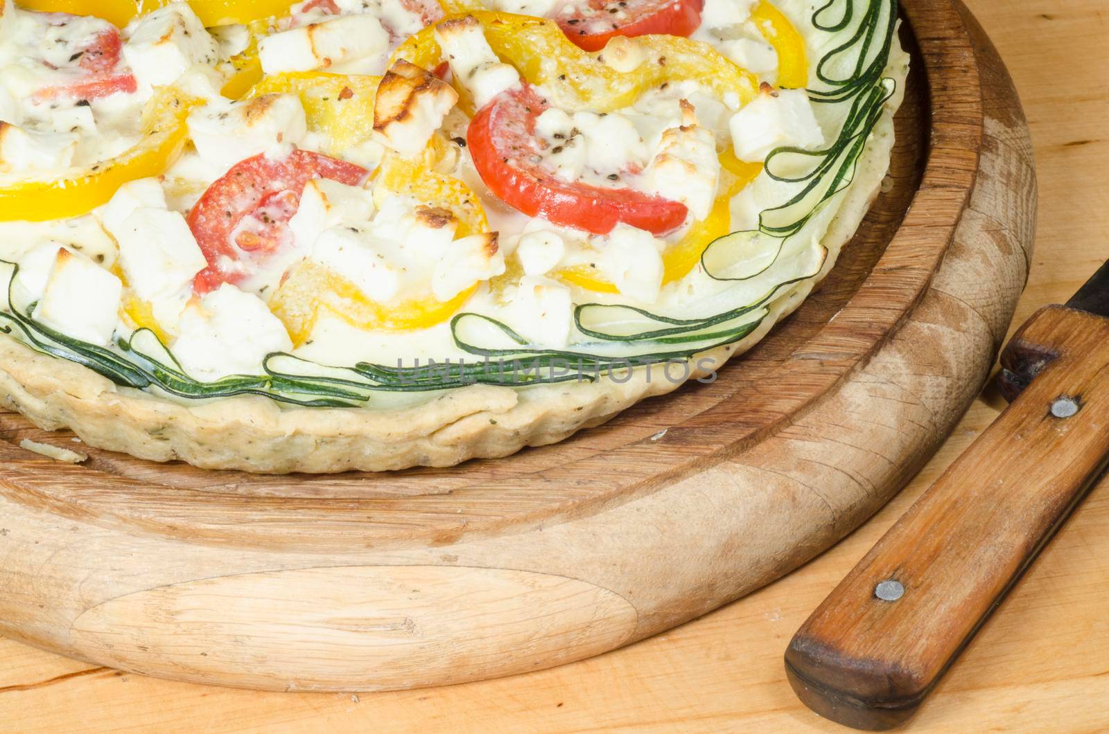 Ready vegetable pie on wooden cutting board. From series "Cooking vegetable pie"