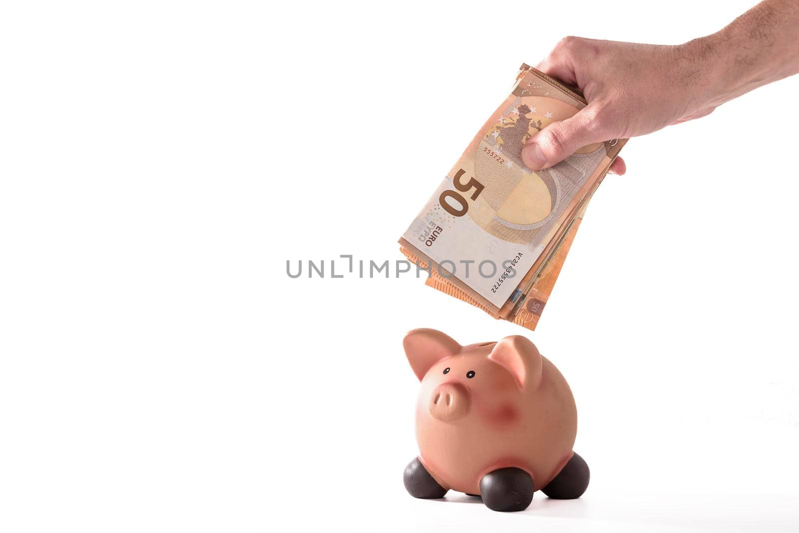 Men putting money coin in the piggy bank for saving money wealth and financial concept. by jbruiz78