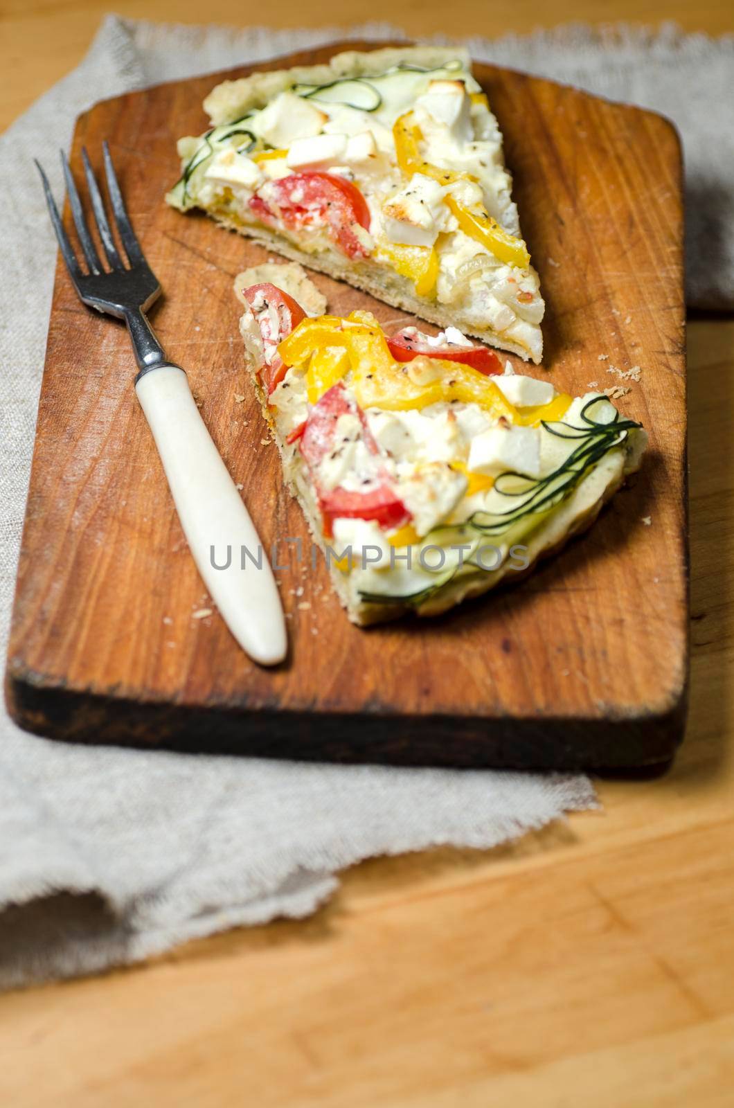 Two slices of vegetable pie on wooden cutting board. From series "Cooking vegetable pie"