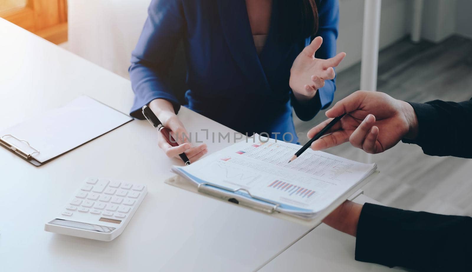 Two businessman and businesswoman investment consultant analyzing company financial report balance sheet statement working with documents graphs. Concept picture for stock market, office, tax,and project..