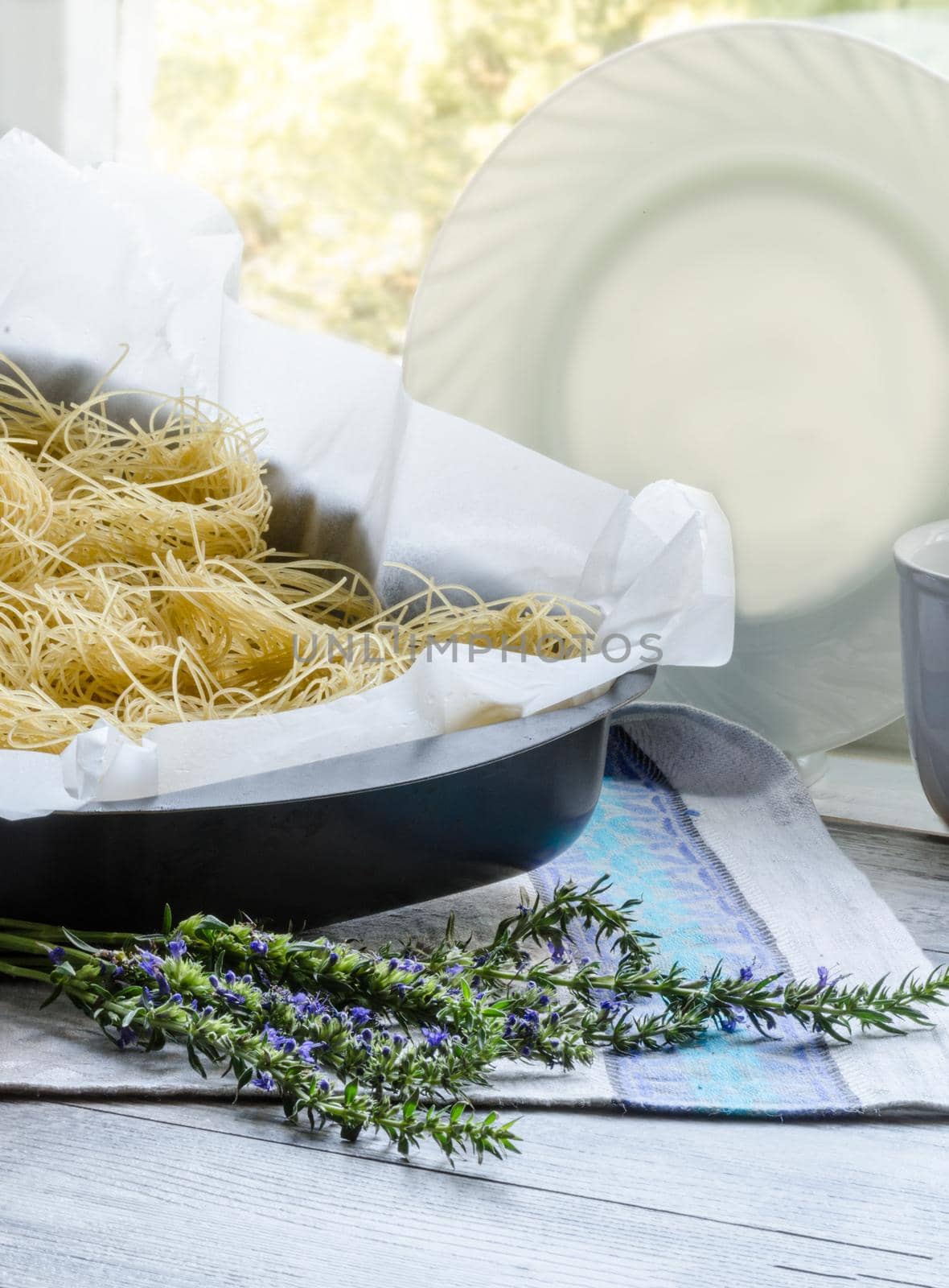 Raw pasta in a baking dish Cooking Easter dessert with raspberries and whipped cream From series Sweet pasta