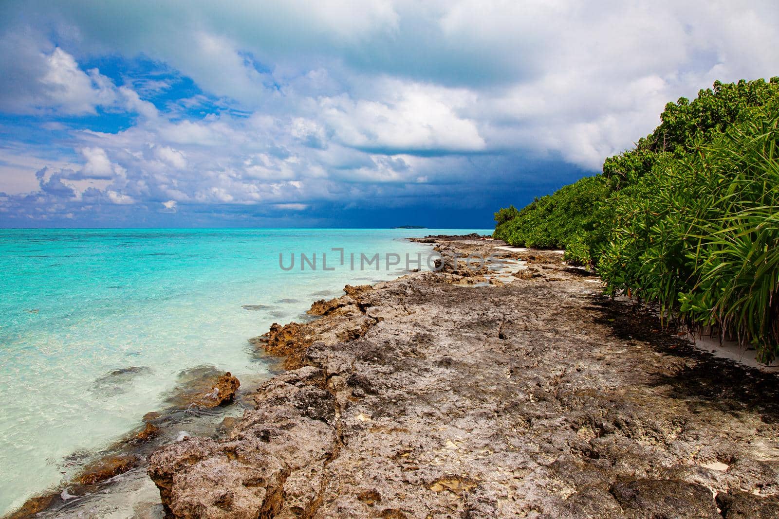 Turquoise blue sea water shore and cloudy sky by kisika