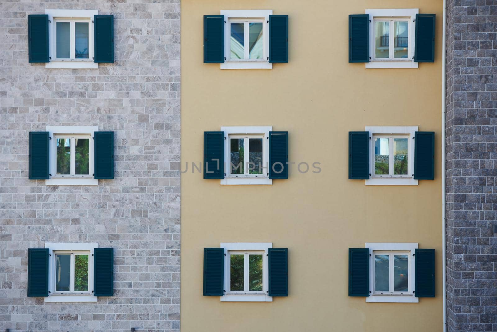Windows with shutters on an apartment building.