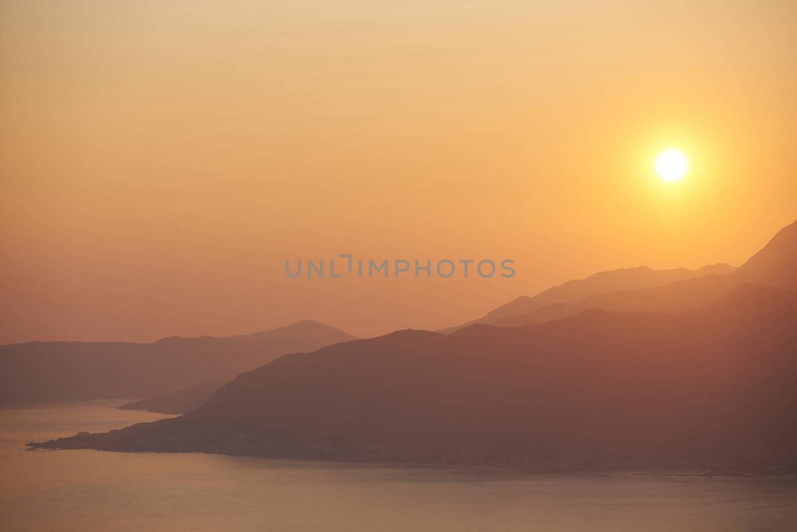 Landscape with sunset, sea and mountains in Montenegro.