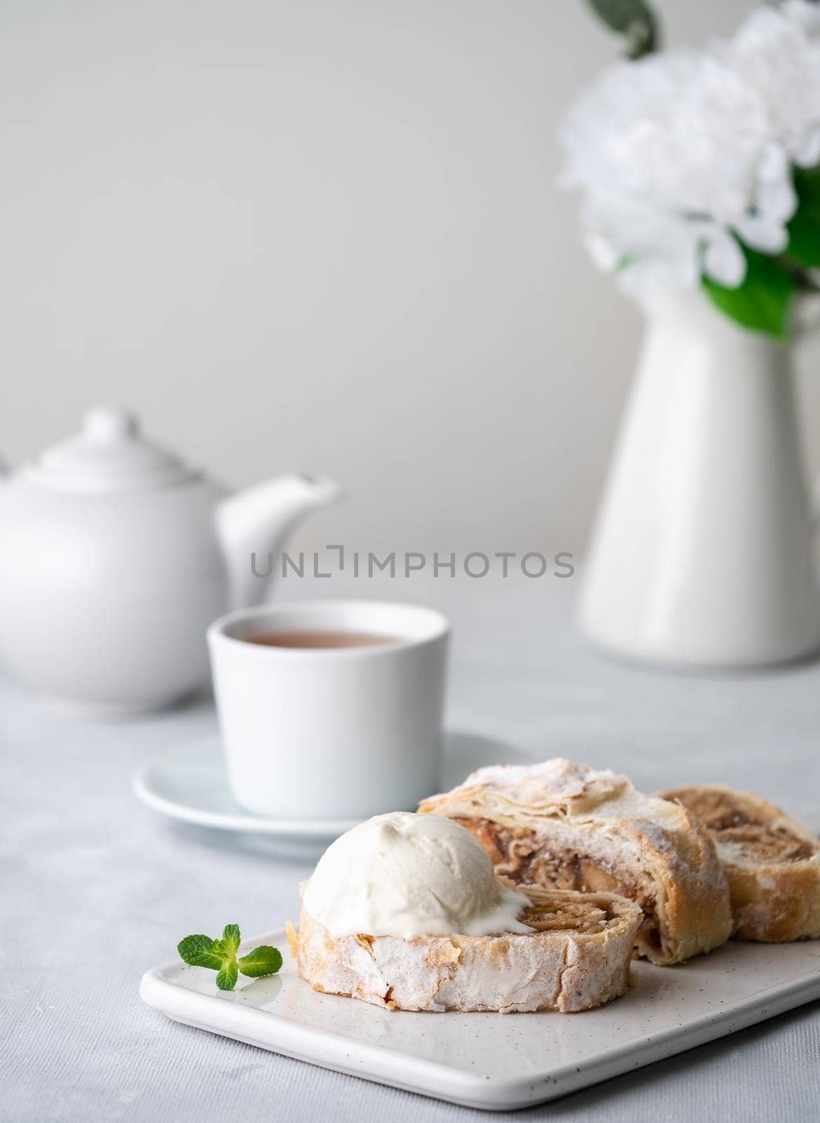 Apple strudel with ice cream and cinnamon. Baked cake and tea, delicious dessert by NataBene
