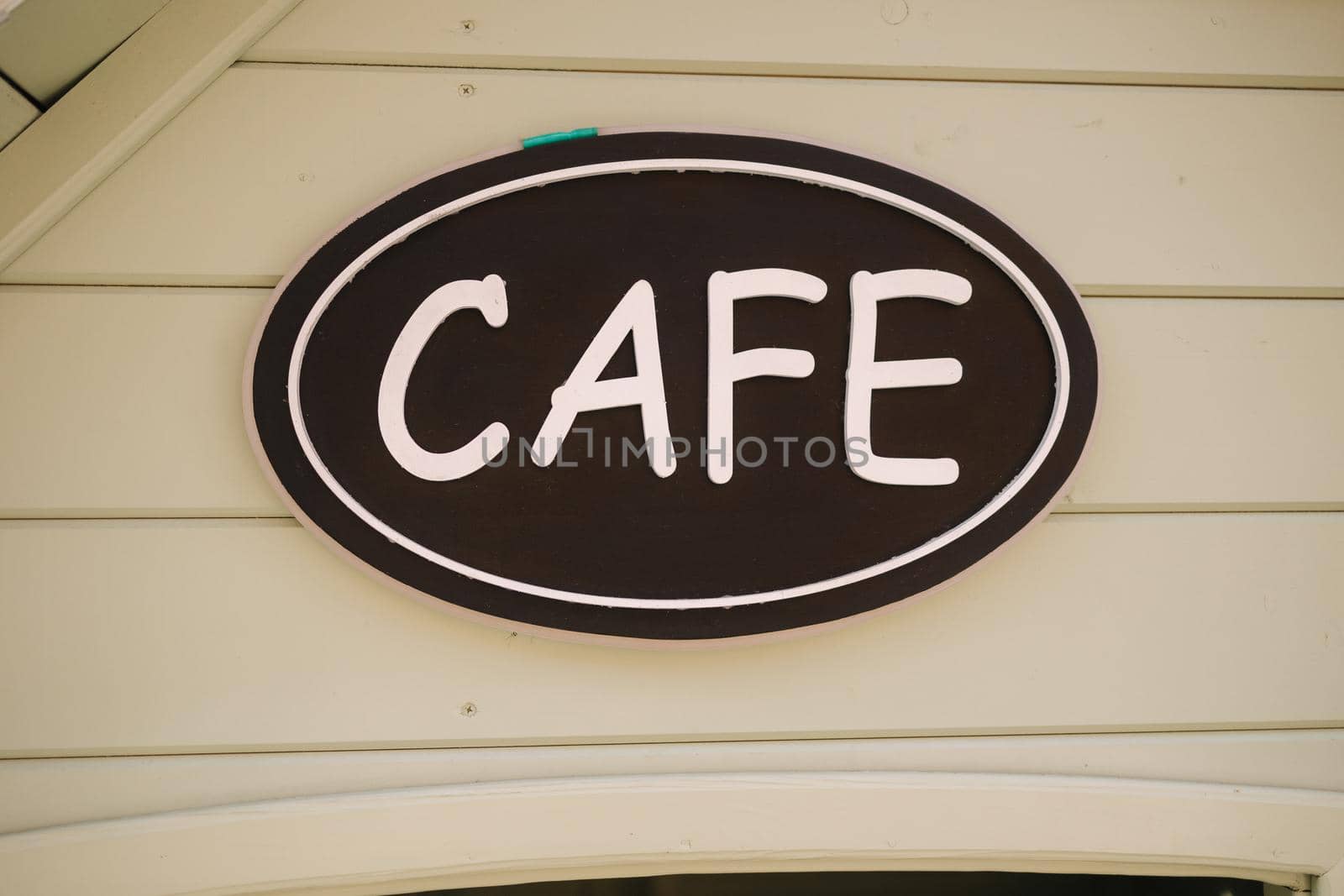 Cafe inscription icon. White on black. Facade of wooden planks.