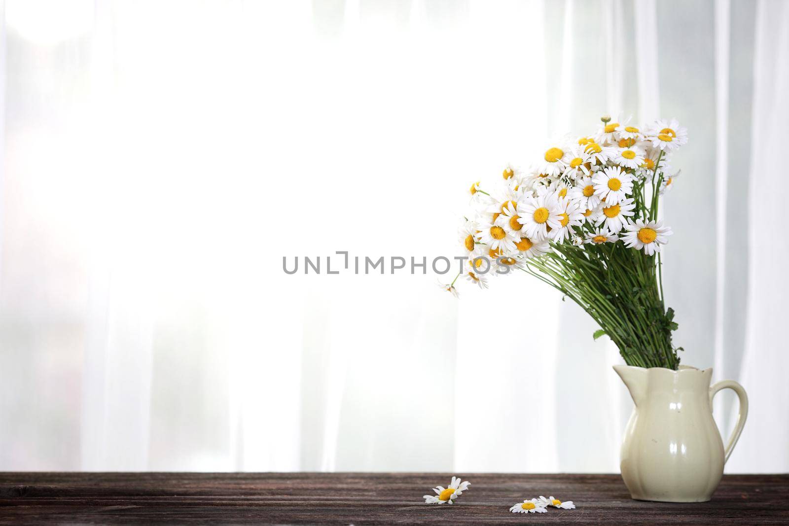 Bouquet of wildflowers on a rustic table at country cottage