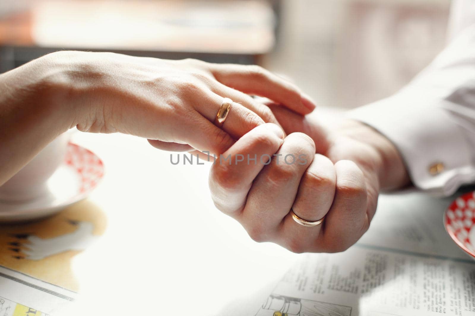 bride and groom holding hands in a cafe