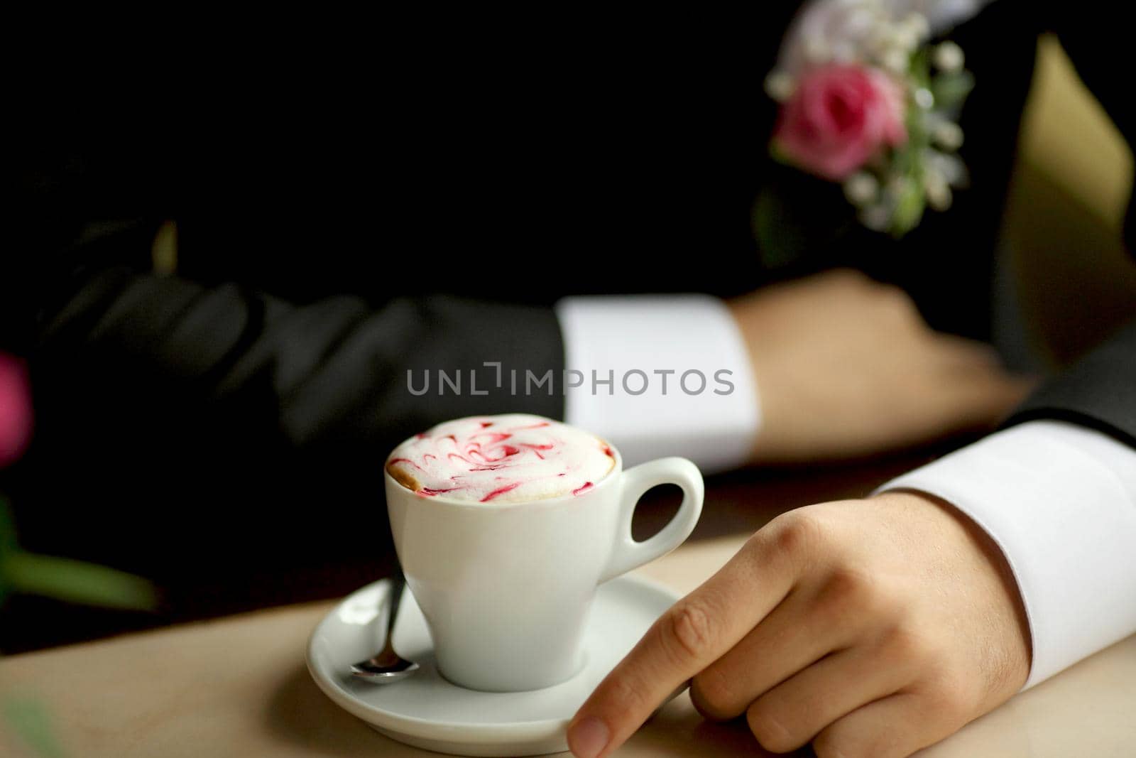 Groom's hands holding cup of coffee men