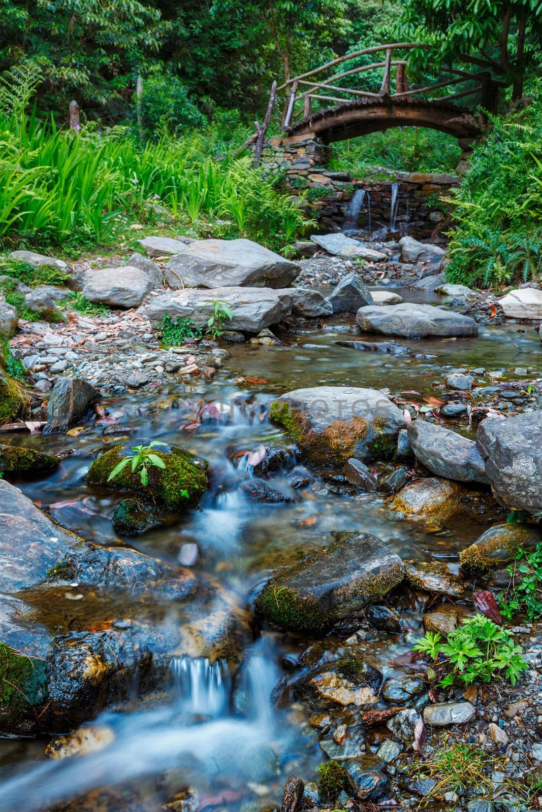 Small waterfall on mountain stream with small bridge. Jibi, Himachal Pradesh