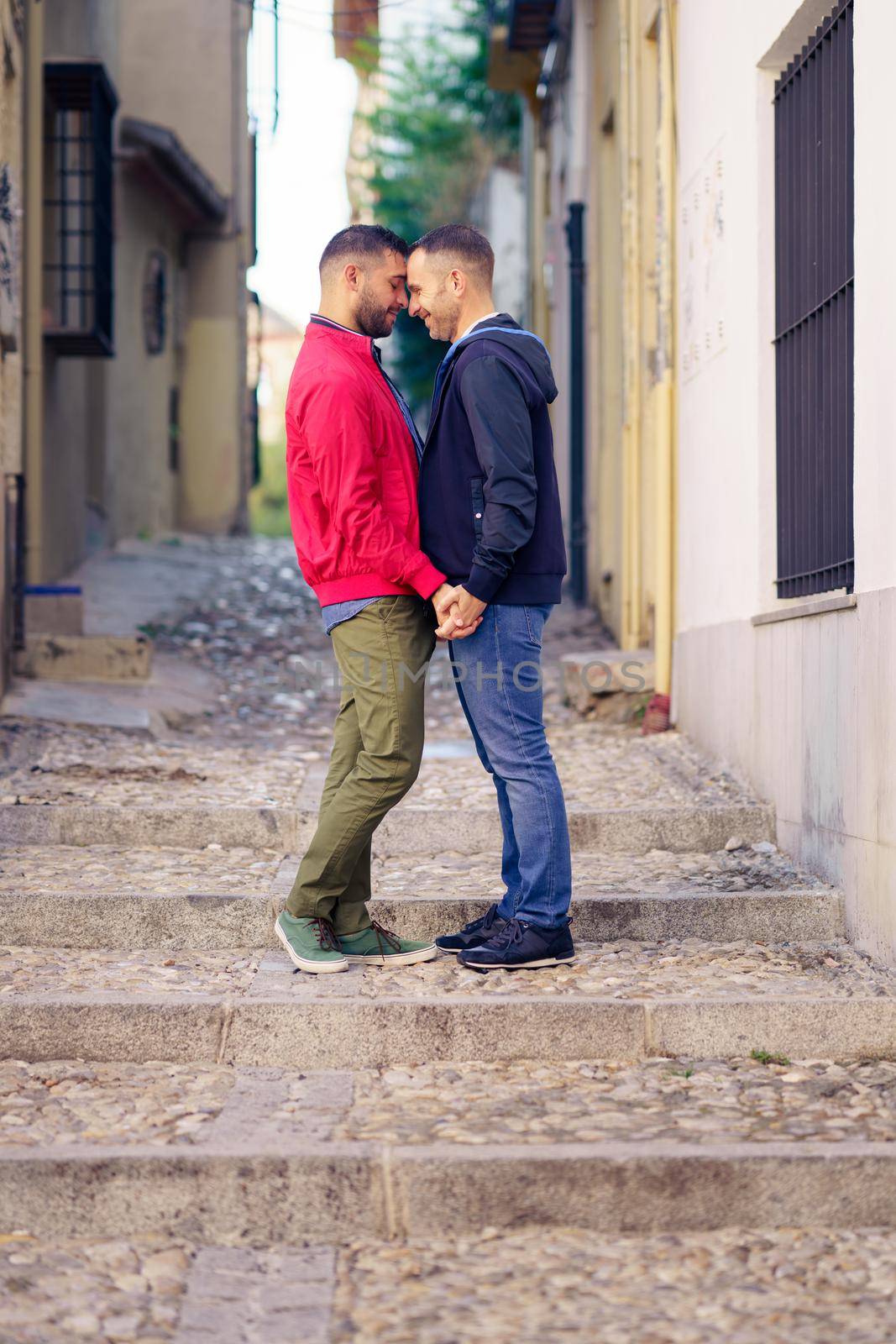 Gay couple in a romantic moment in the street. by javiindy