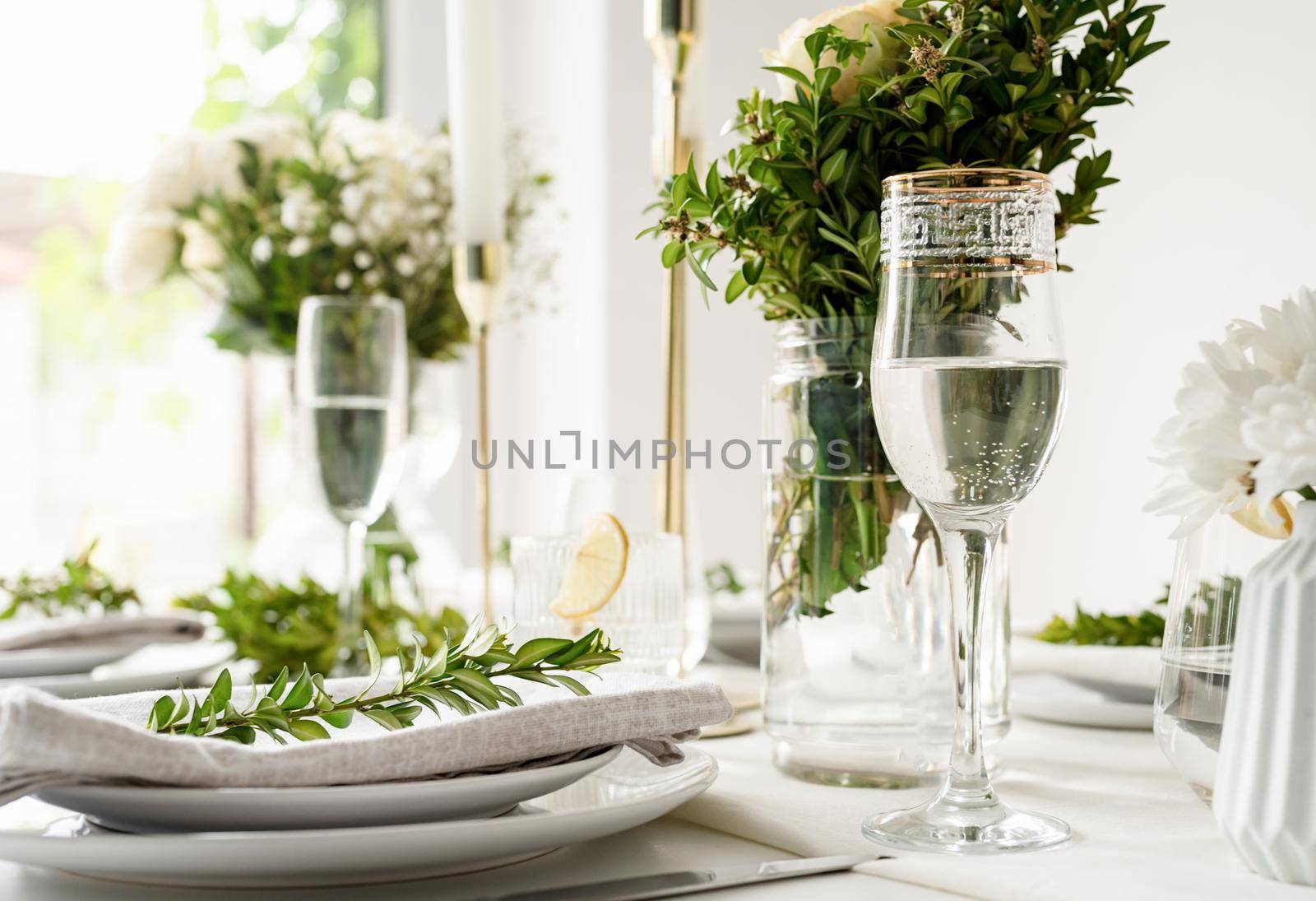 Wedding table set up in taditional style with roses and greenery. Wedding table scapes, front view table setting