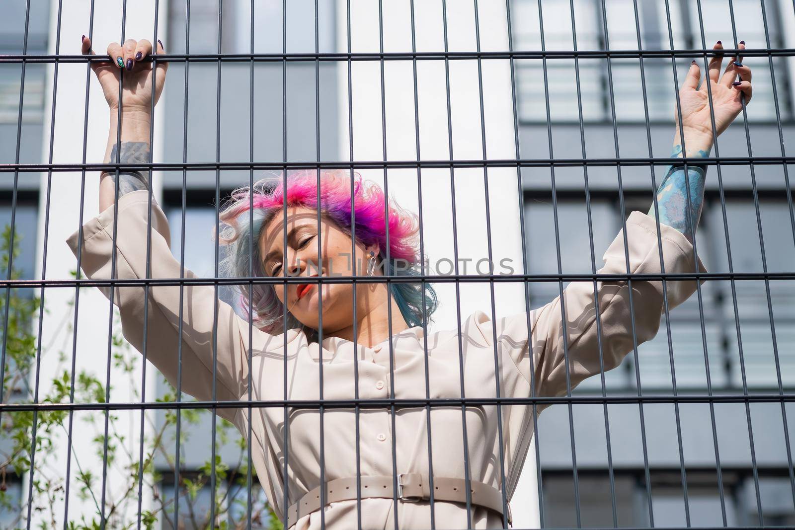 Portrait of a middle-aged woman with multi-colored hair walks on the streets of the city