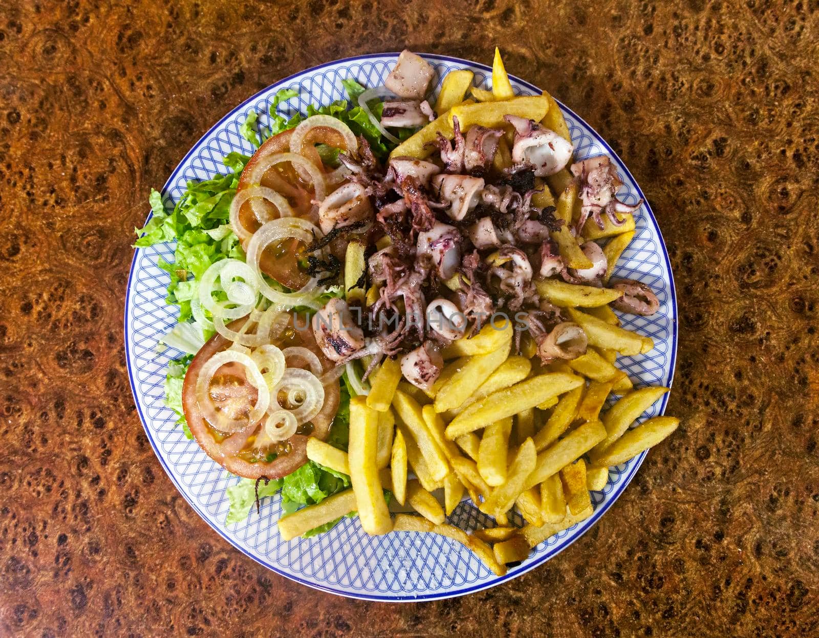 Baby octopuses and french fries on a plate by Goodday