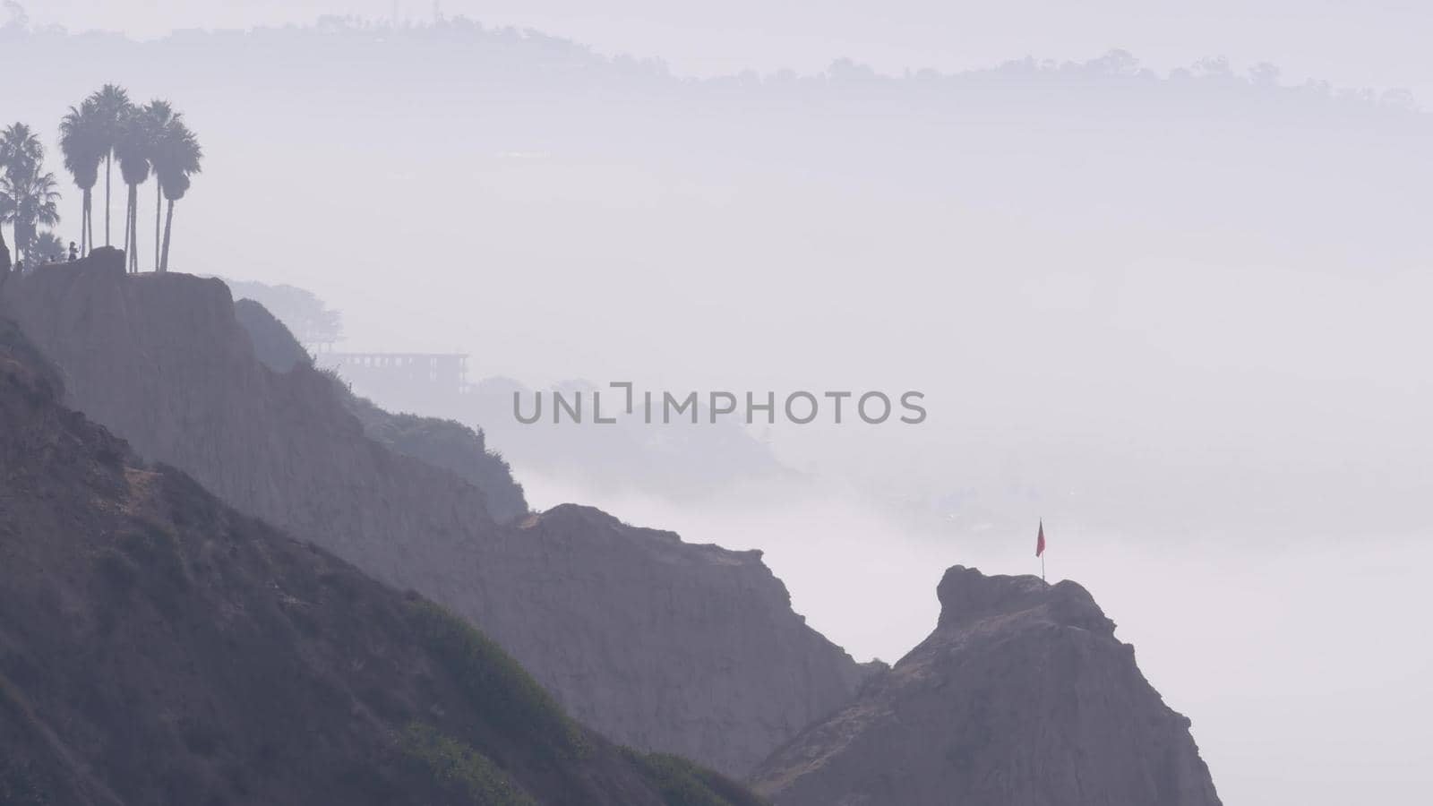 Steep cliff, rock or bluff, California coast erosion. Torrey Pines in misty fog. by DogoraSun
