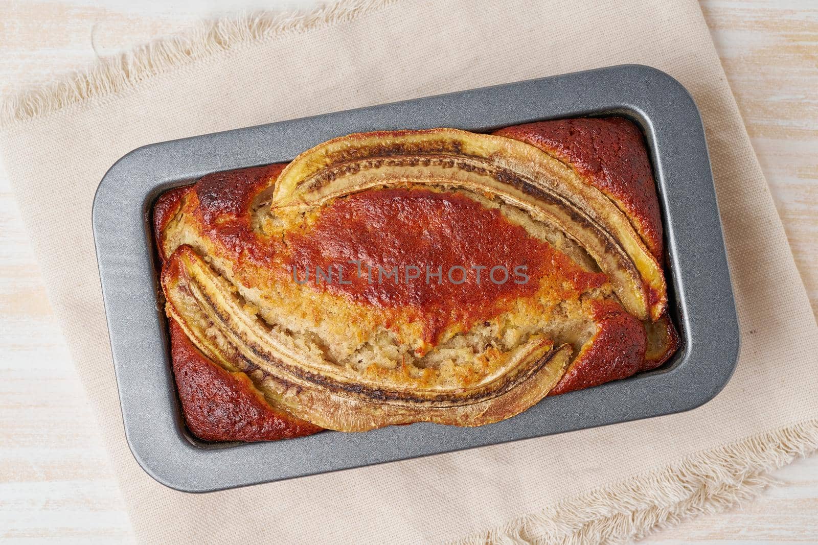 Banana bread in pan. Cake with banana, chocolate, walnut. Traditional american cuisine