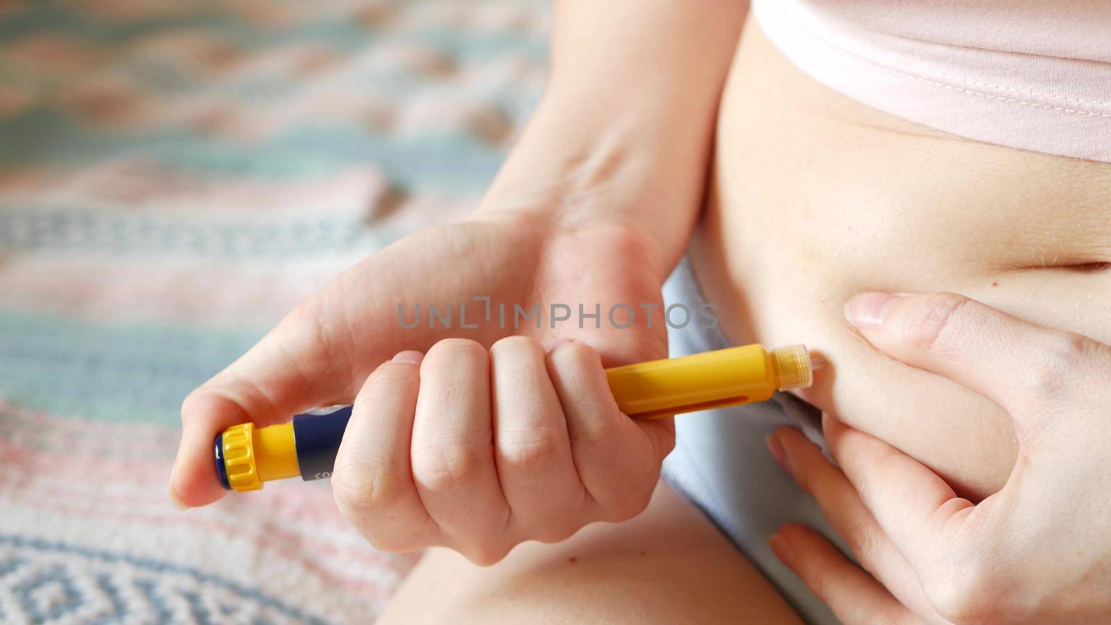 Females stomach, belly or abdomen. Woman injecting insulin, injection of hormone by DogoraSun