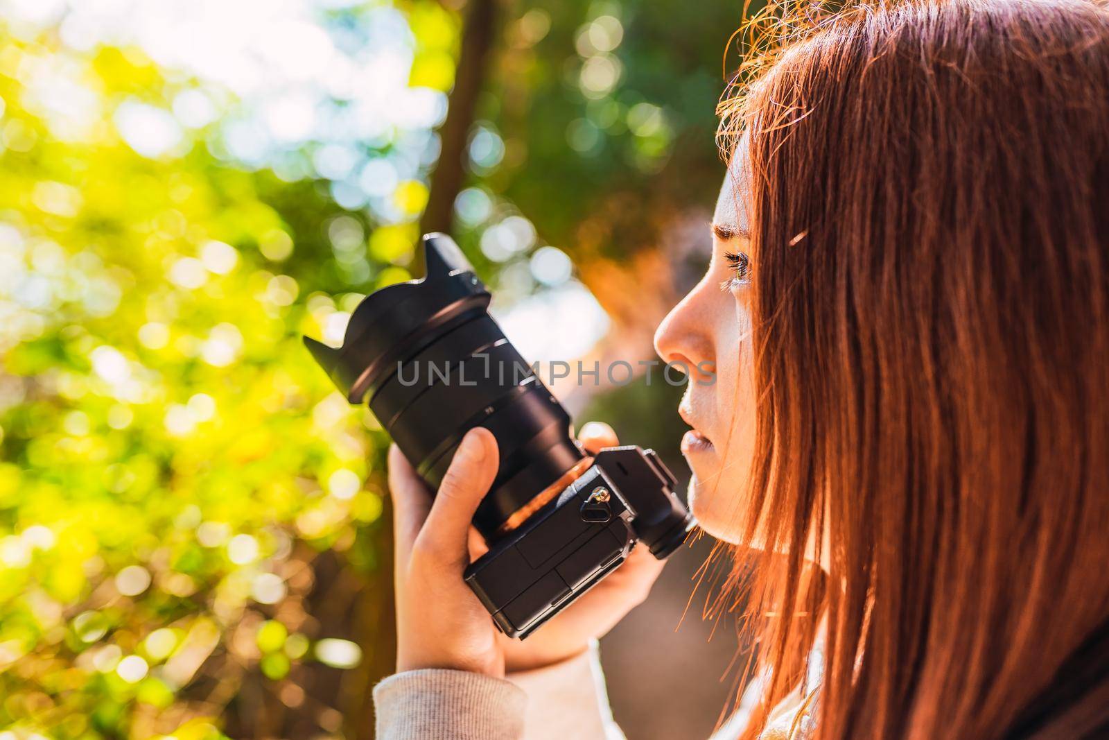 young woman amateur photographer, taking pictures of a mountain landscape. young redhead photographing wildlife. trip. by CatPhotography