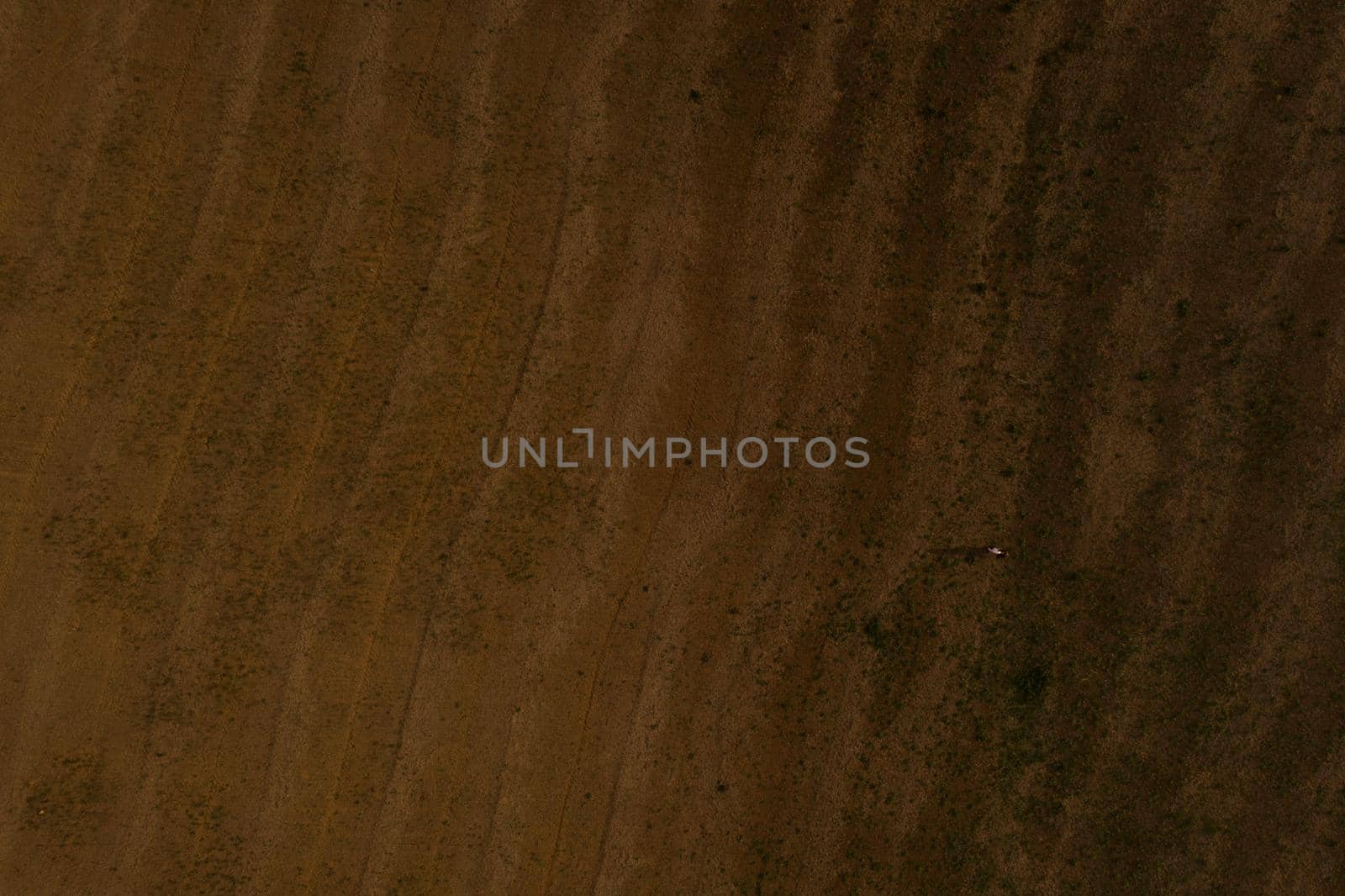 Aerial view from above. wavy field. brown earth. texture background.