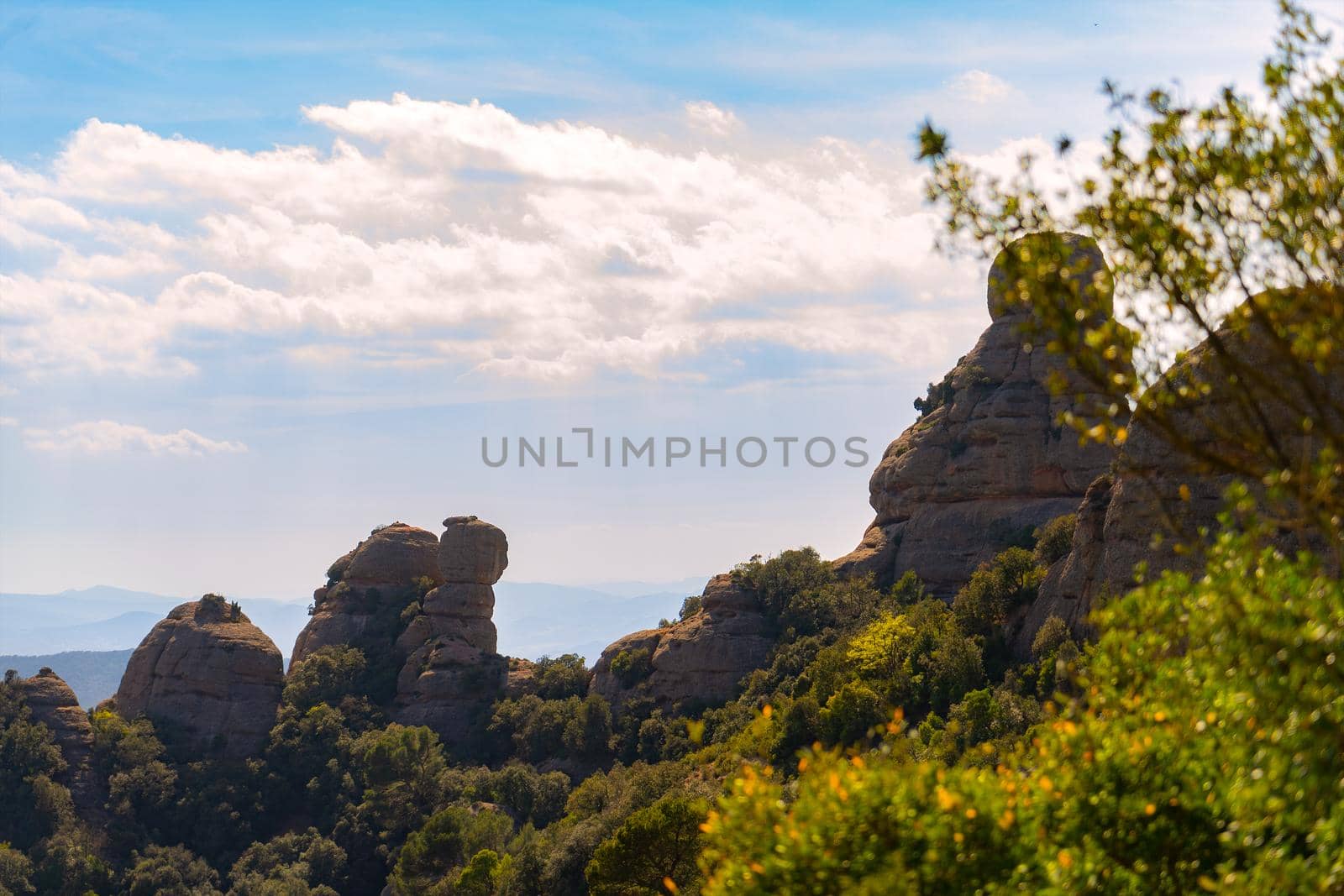 mountain scenery. rocky mountains, green sunlit plants and blue sky. Mountain of Montserrat Spain. Mediterranean view. warm weather, spring or summer season. holiday resort.