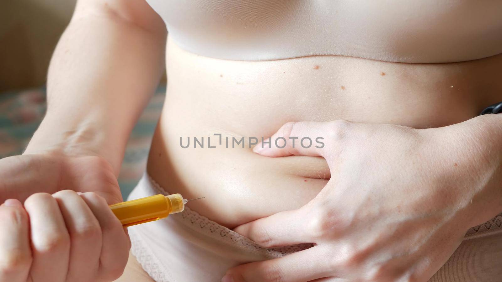 Female makes injection in stomach, belly or abdomen. IVF in vitro fertilisation, reproductive infertility, sterility treatment. Hormonal drugs, ovulation stimulation. Woman injecting insulin, diabetes