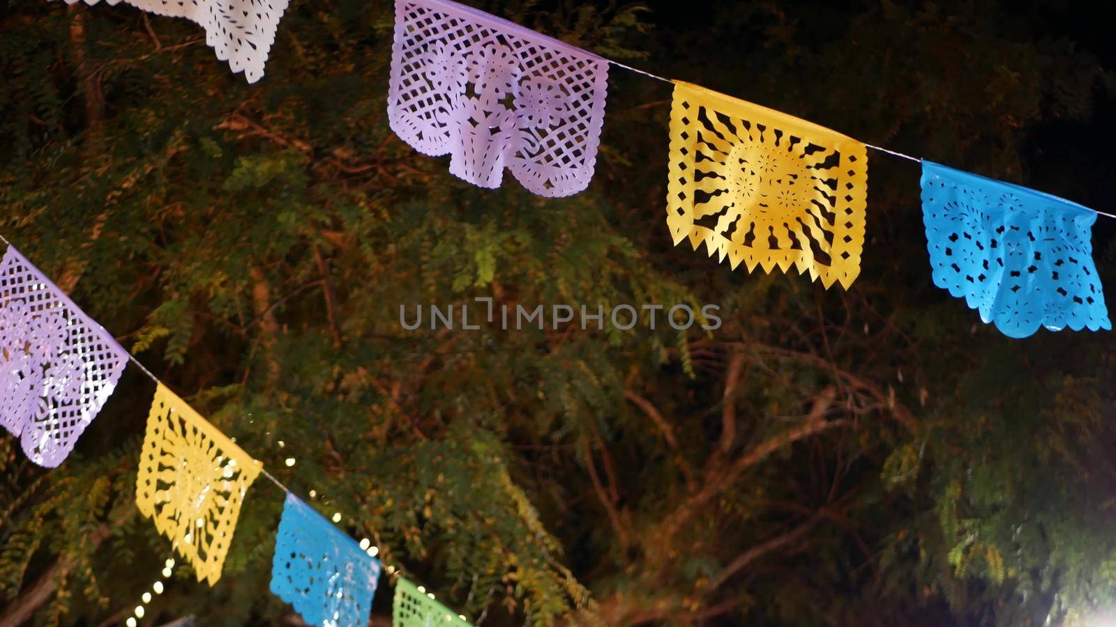 Papel picado garland, paper tissue perforated flags. Mexican colorful ethnic decor for holiday, carnaval, party or fiesta. Festival street decoration, Cinco de Mayo, Day of Dead or Dia de Muertos.