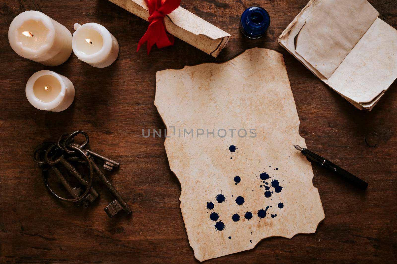 parchment with ink stains near candles keys