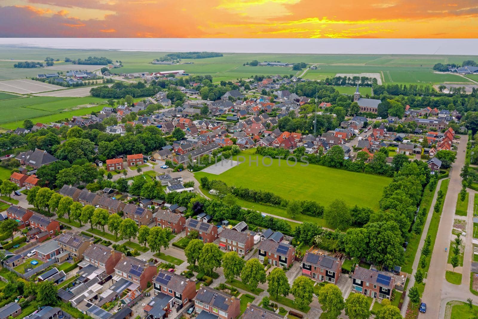 Aerial view on the medieval village Ternaard in Friesland the Netherlands at sunset by devy