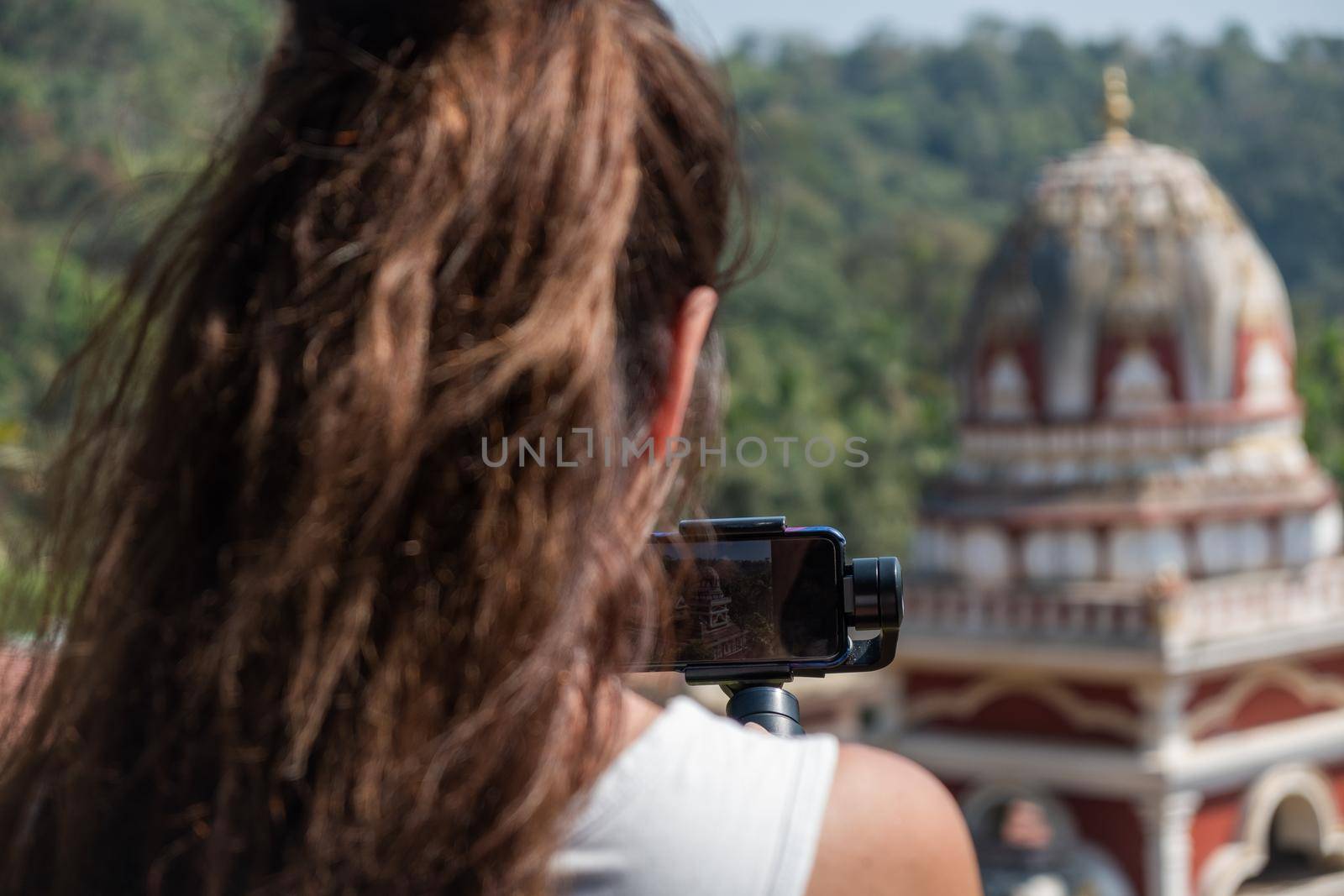 Young woman taking picture of Indian Temple by snep_photo