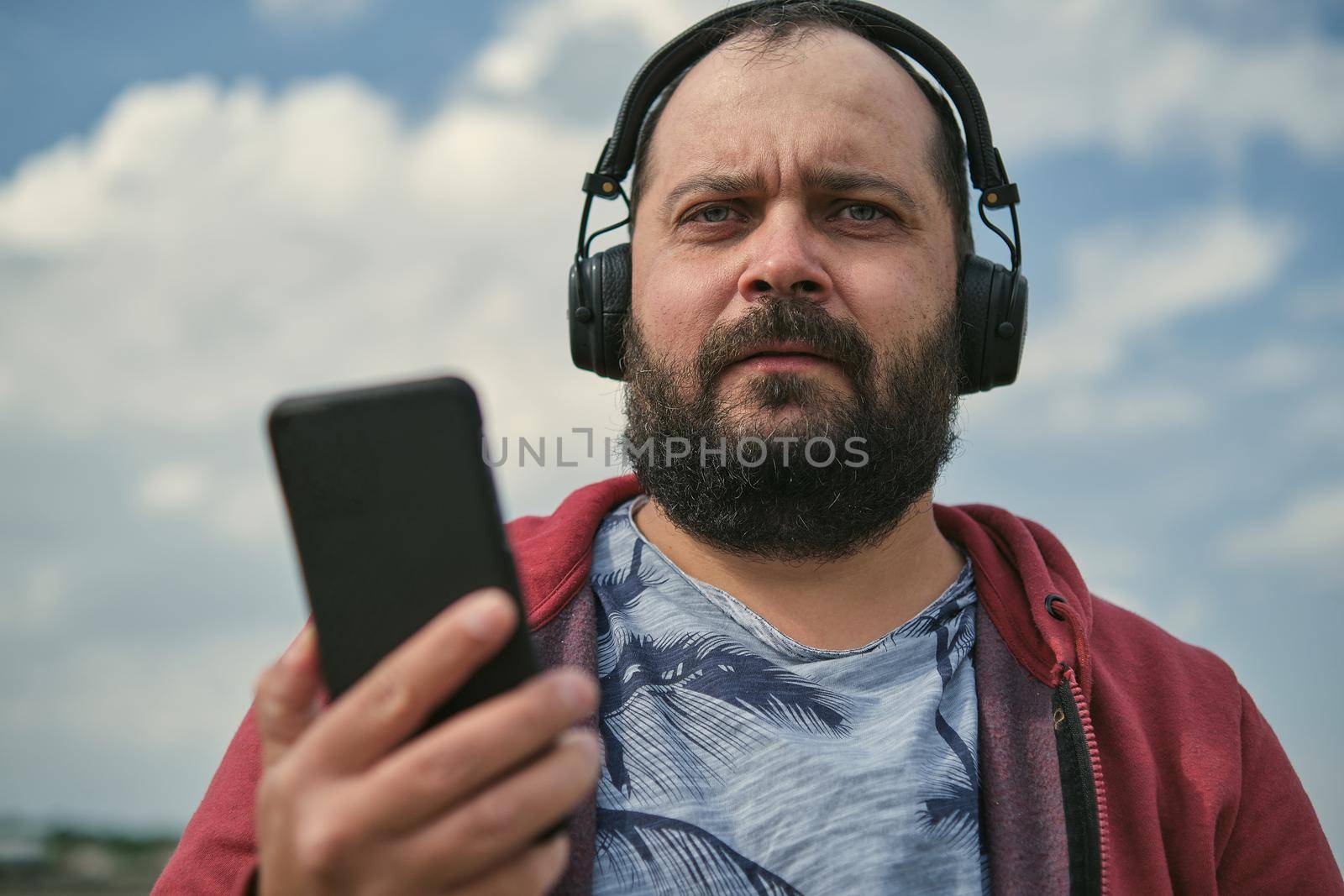 Middle aged man listening to music, close up by snep_photo