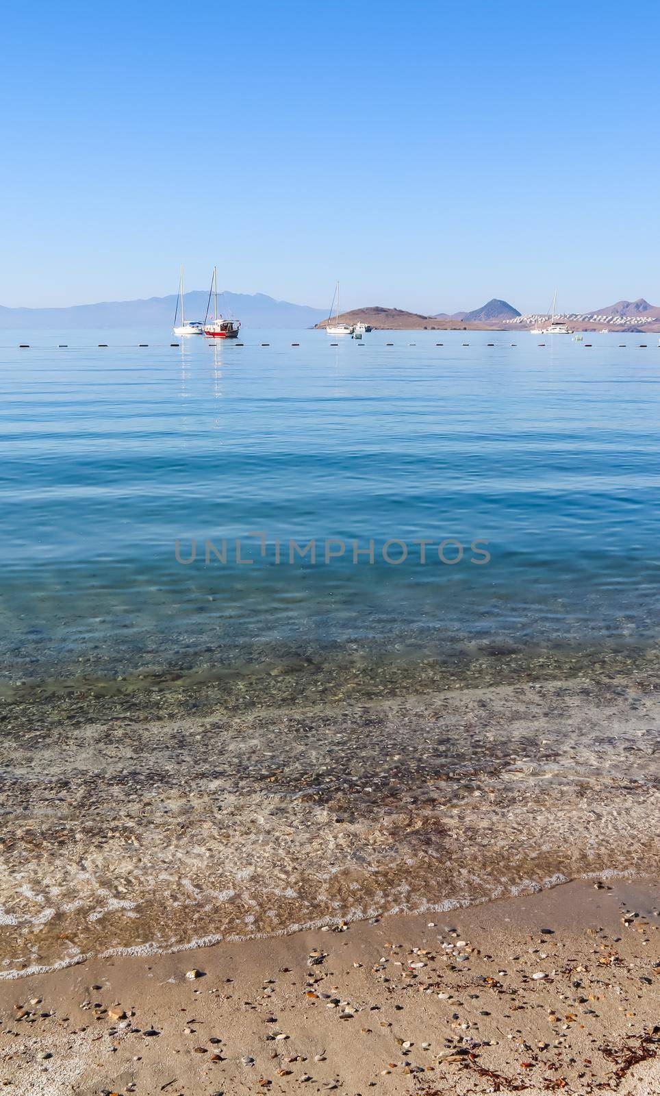 Beautiful calm blue bay with sand beach in Mediterranean. Holiday and relaxation on sea coast