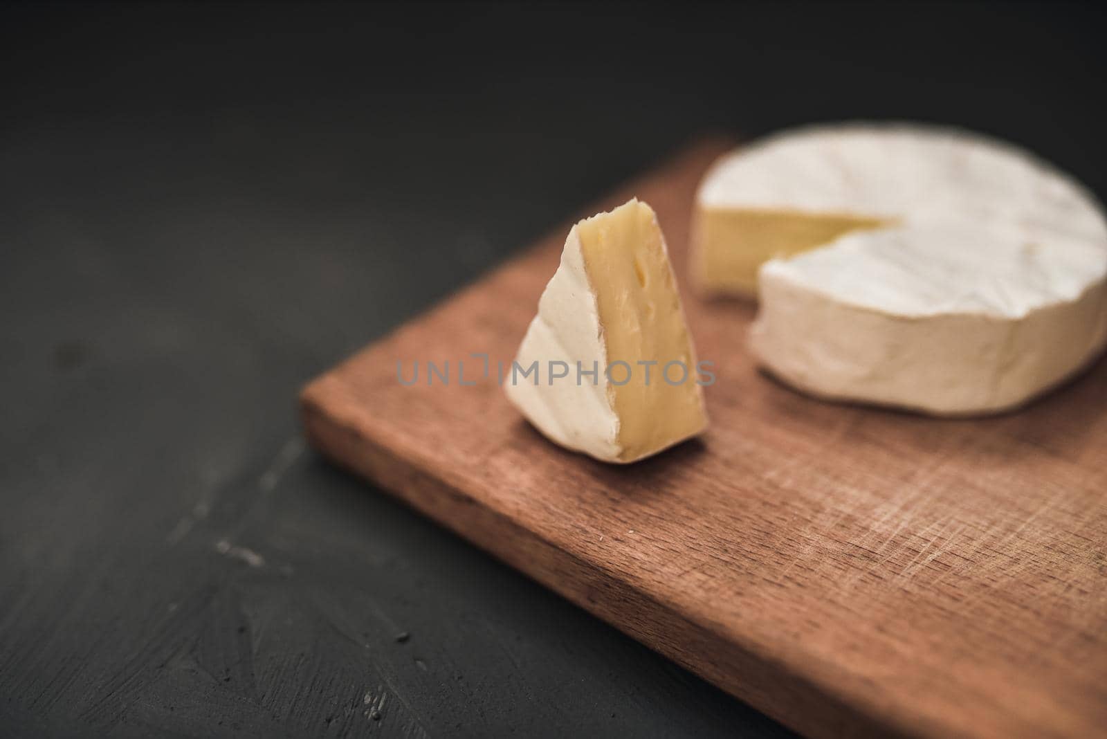 cheese camembert with mold on cutting board by AndriiDrachuk