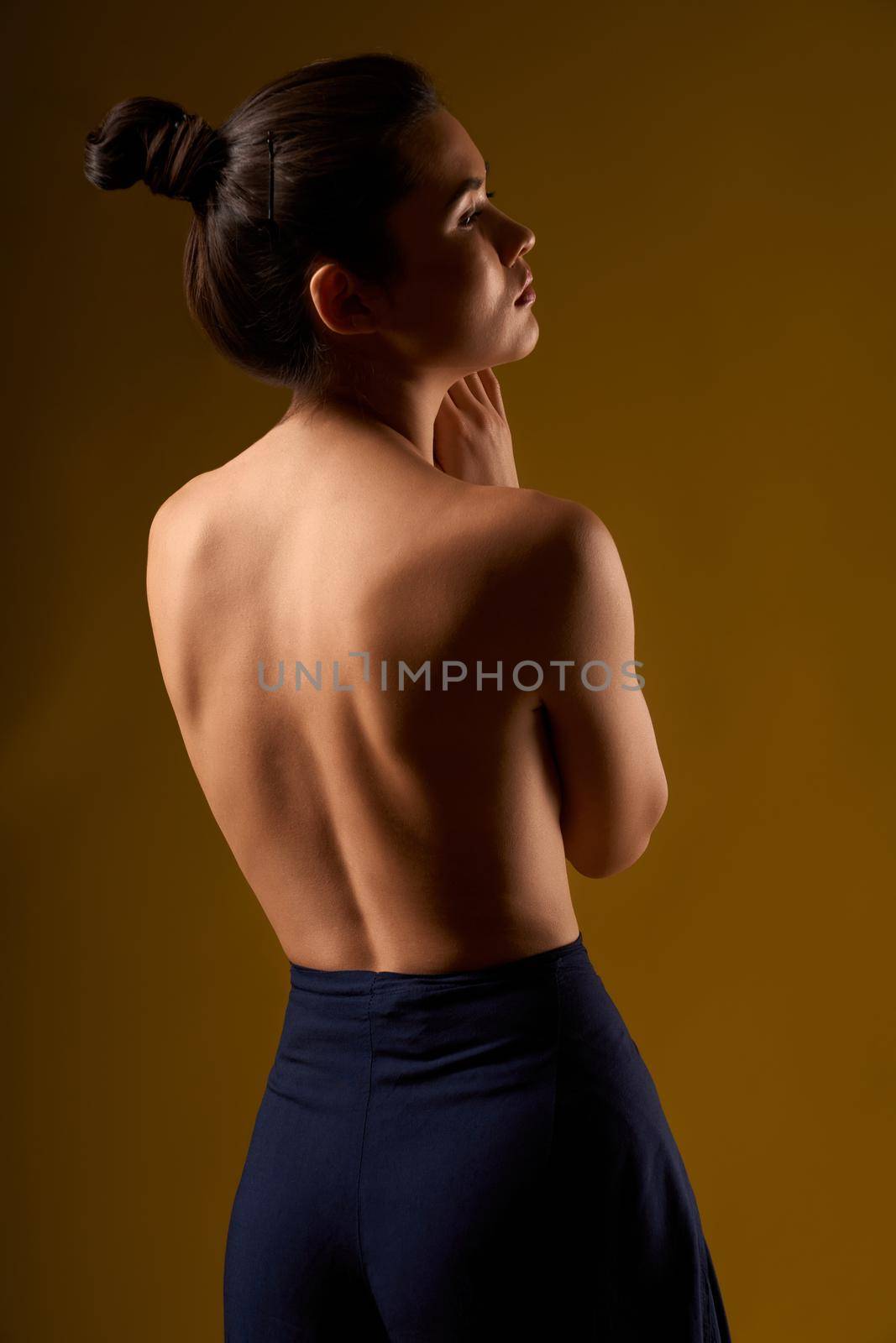 Female with bare back standing, looking forward. by SerhiiBobyk