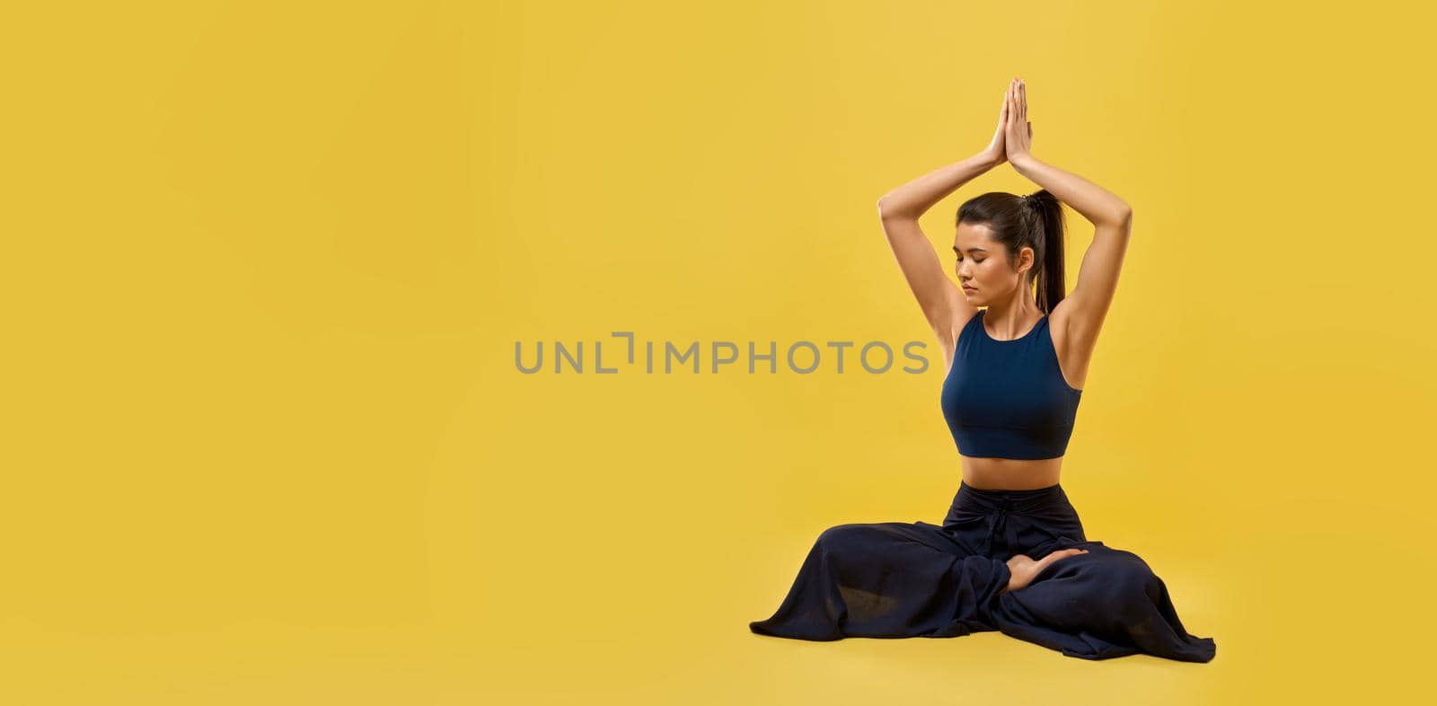 Brunette girl practicing yoga pose at studio. by SerhiiBobyk