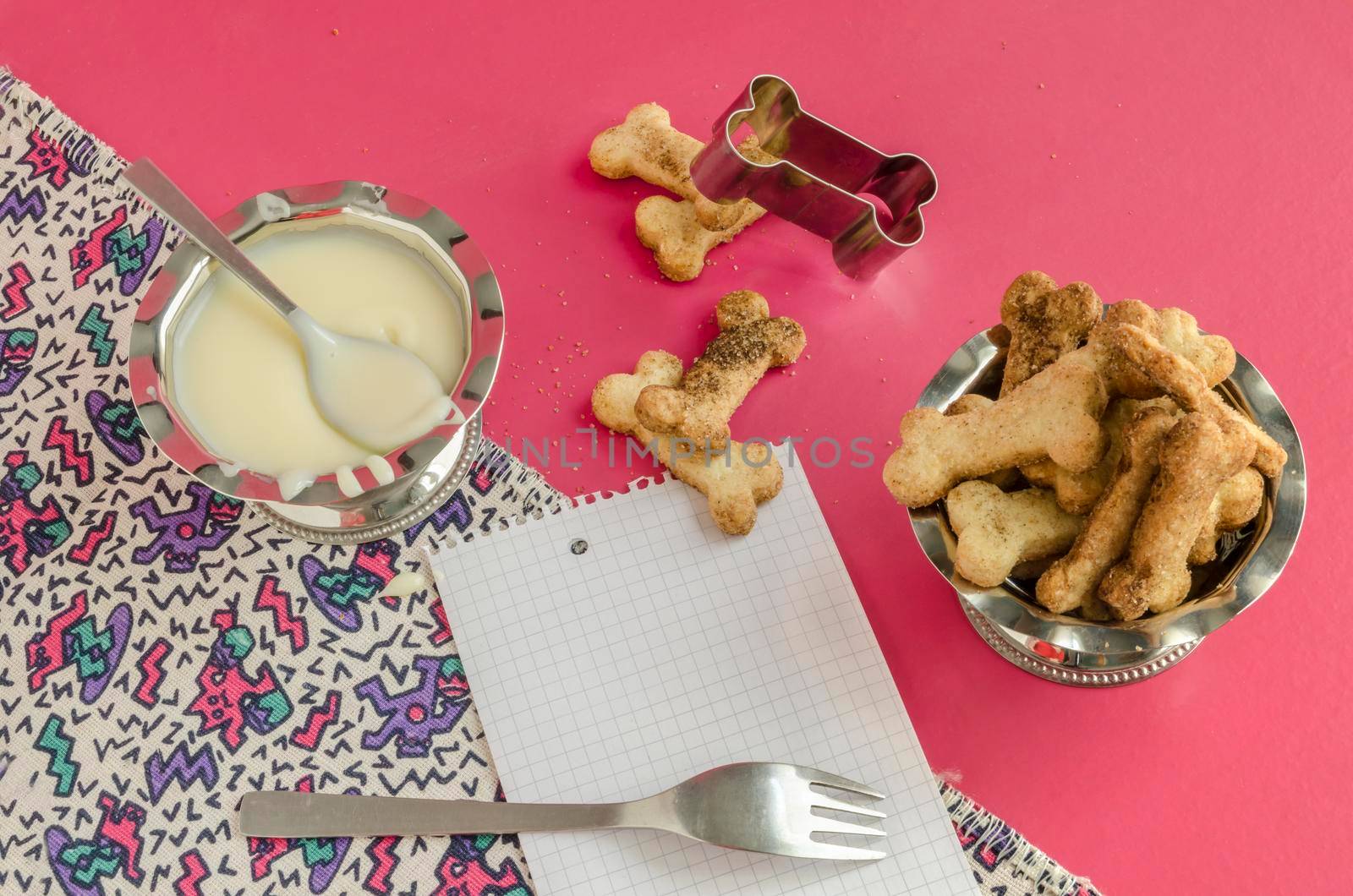 Bone sugar cookies and condensed milk, background for menu From series kids baking recipes