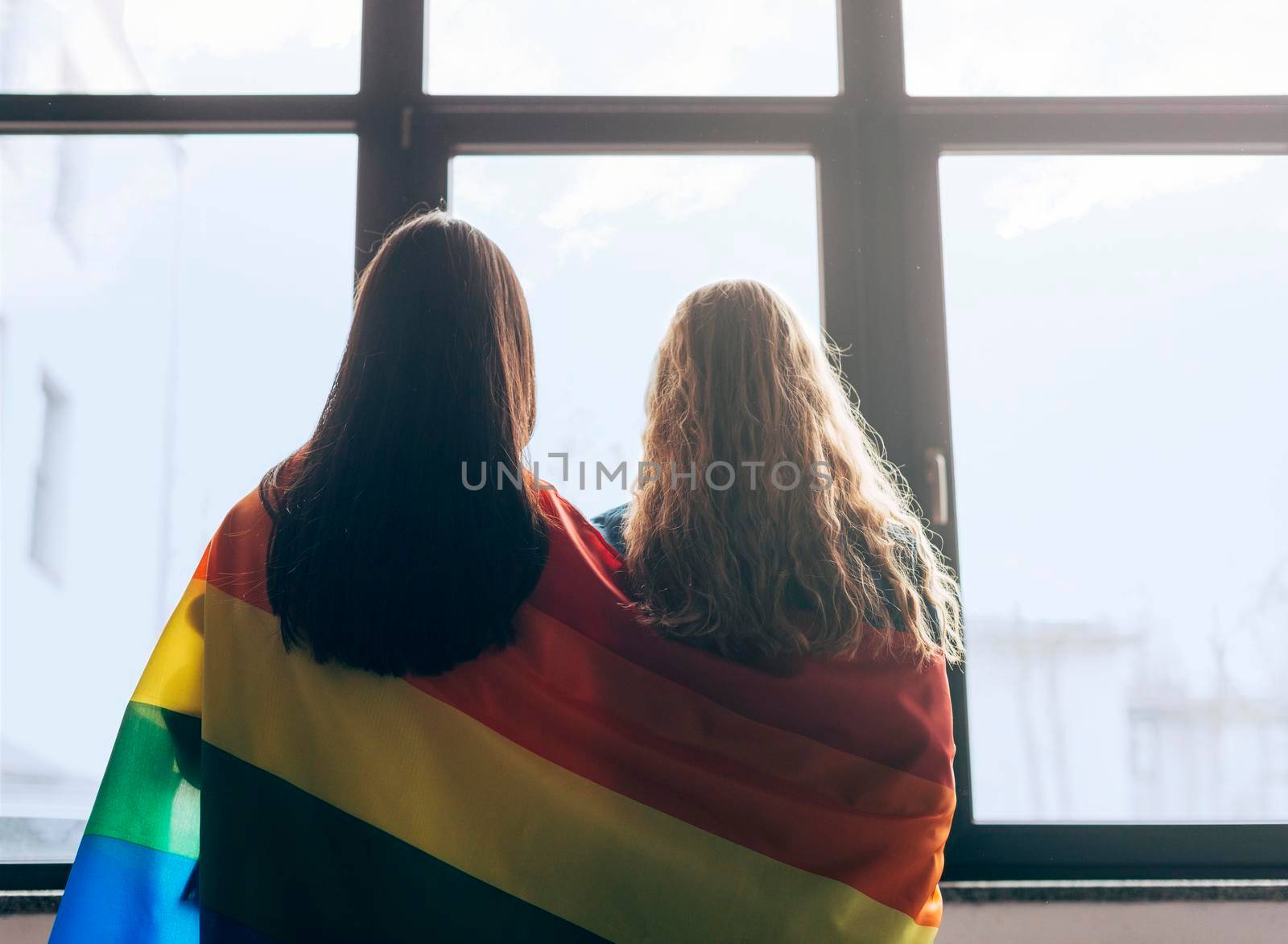 lesbian sweethearts wrapped lgbt flag by Zahard
