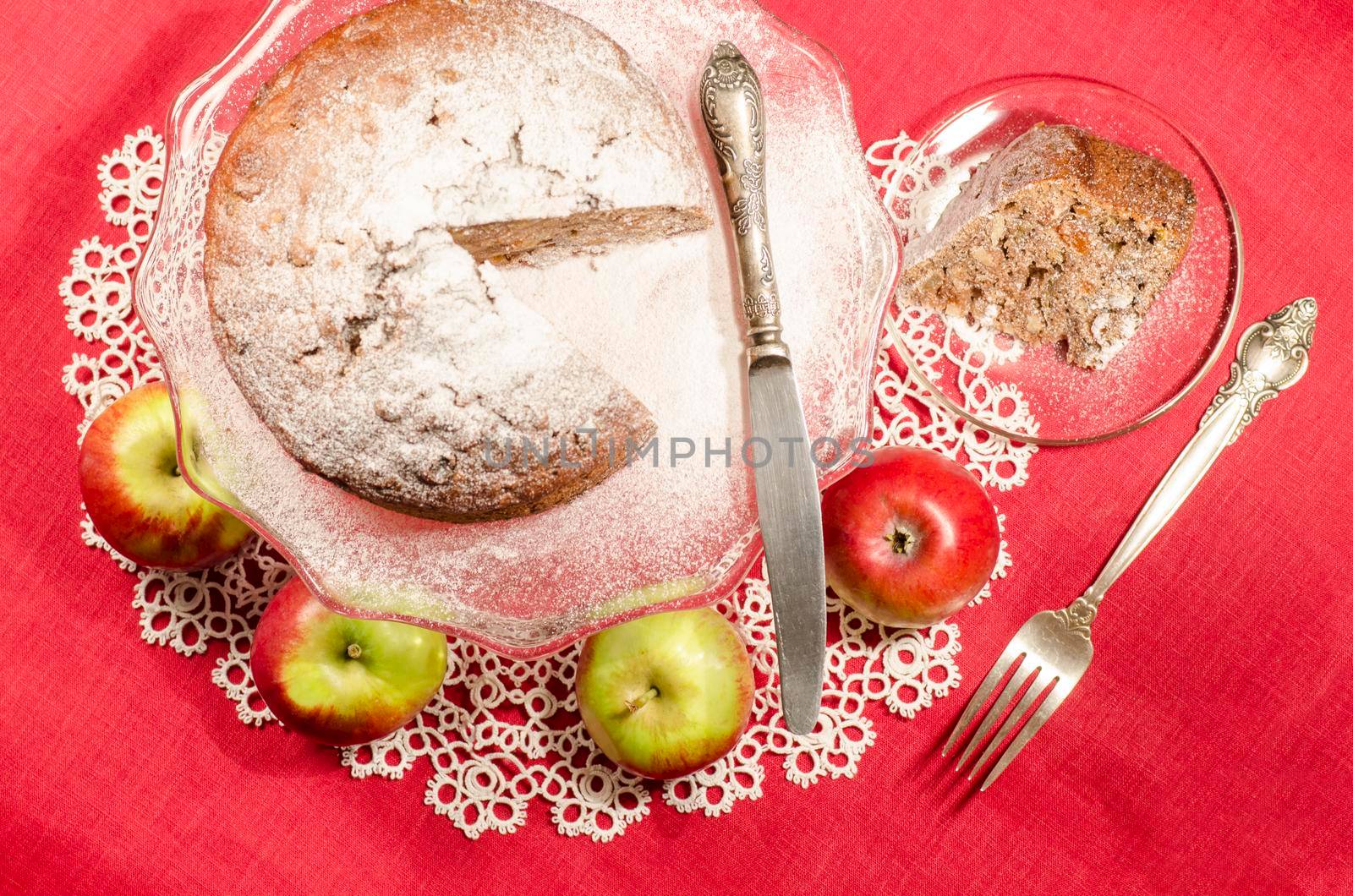Applesauce raisin rum cake for christmas table. Table decorated with lacy napkin. From series of "Merry Christmas"
