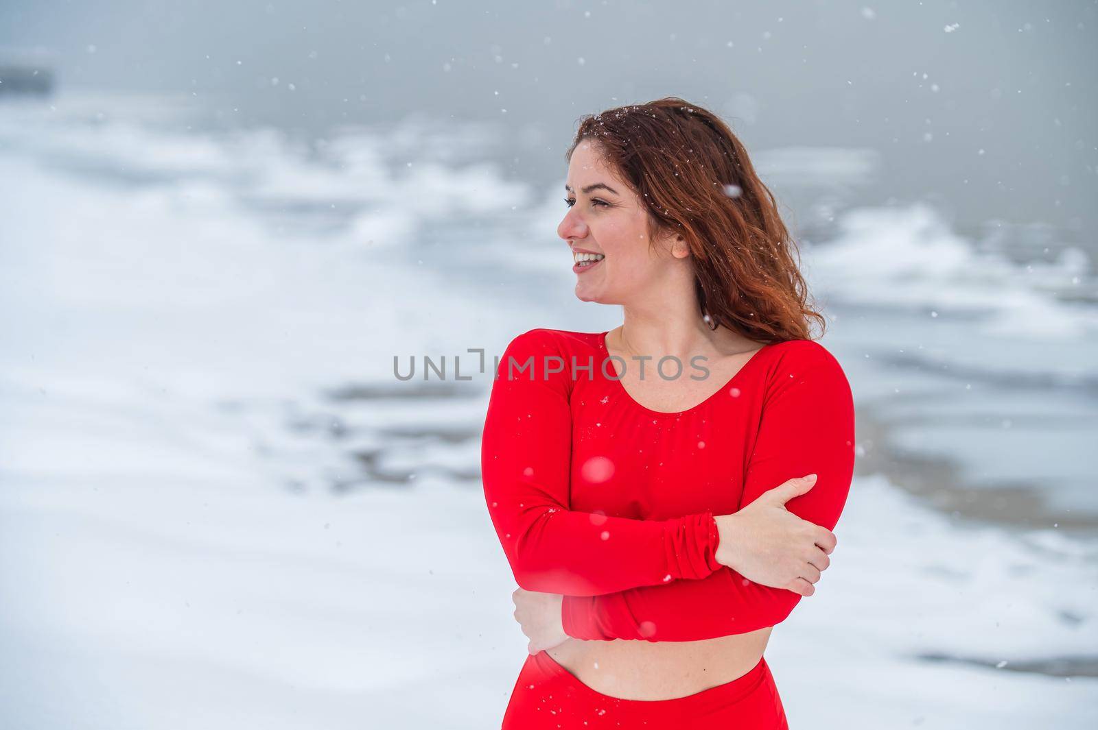 Caucasian red-haired woman posing in lingerie outdoors in winter. by mrwed54